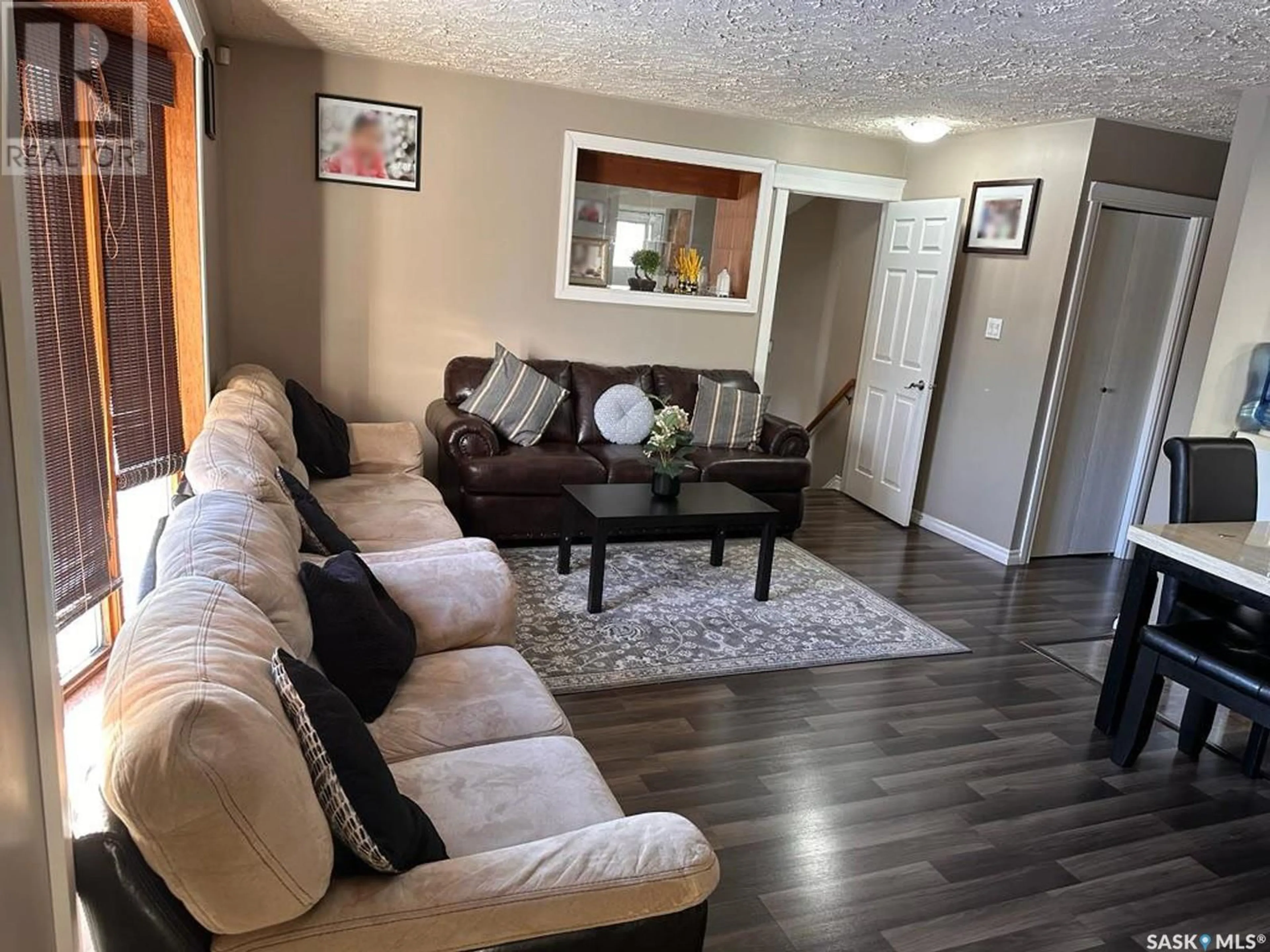 Living room with furniture, wood/laminate floor for 609 2ND STREET, Meadow Lake Saskatchewan S9X1Y9