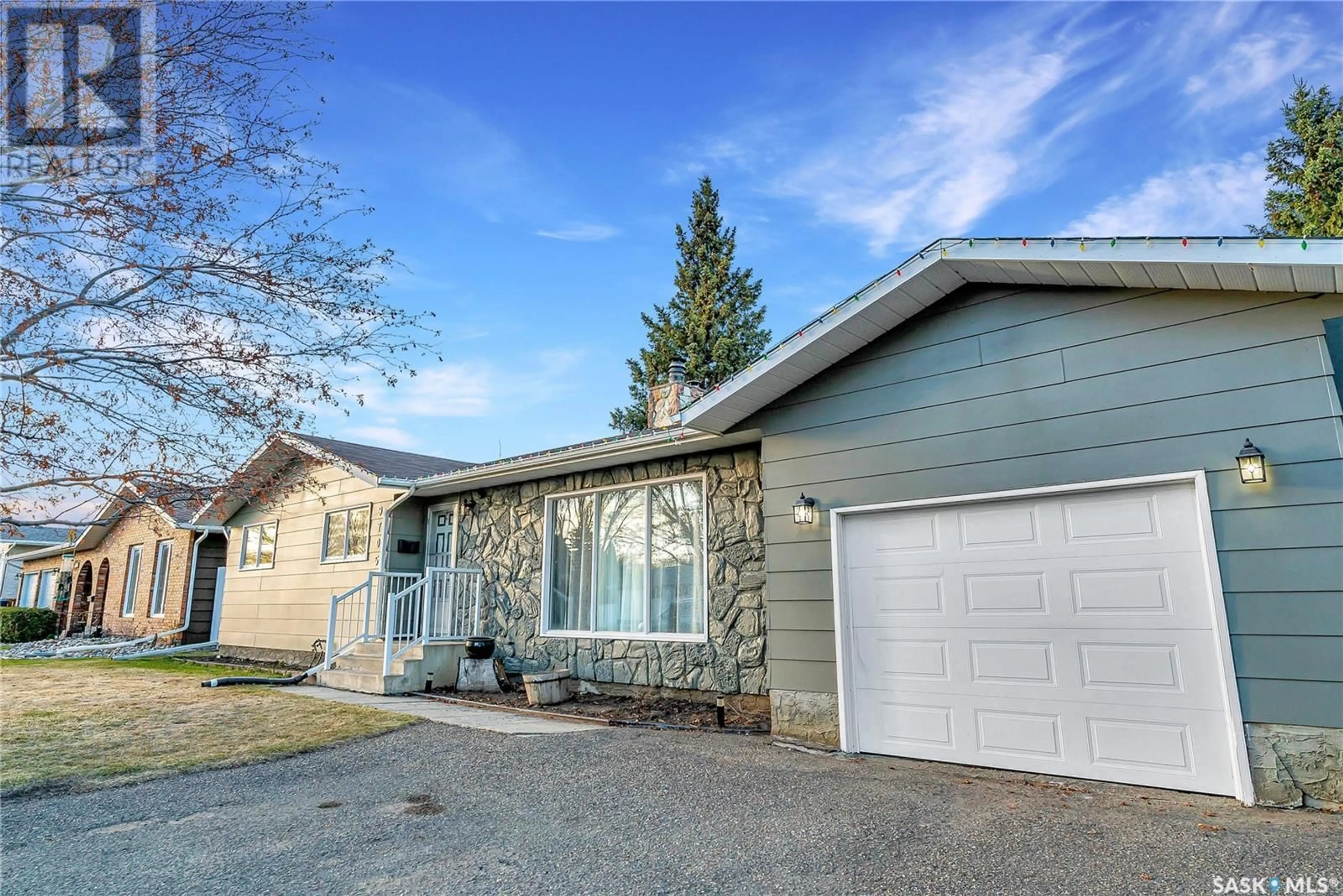 Home with vinyl exterior material, street for 9705 97TH DRIVE, North Battleford Saskatchewan S9A3K3
