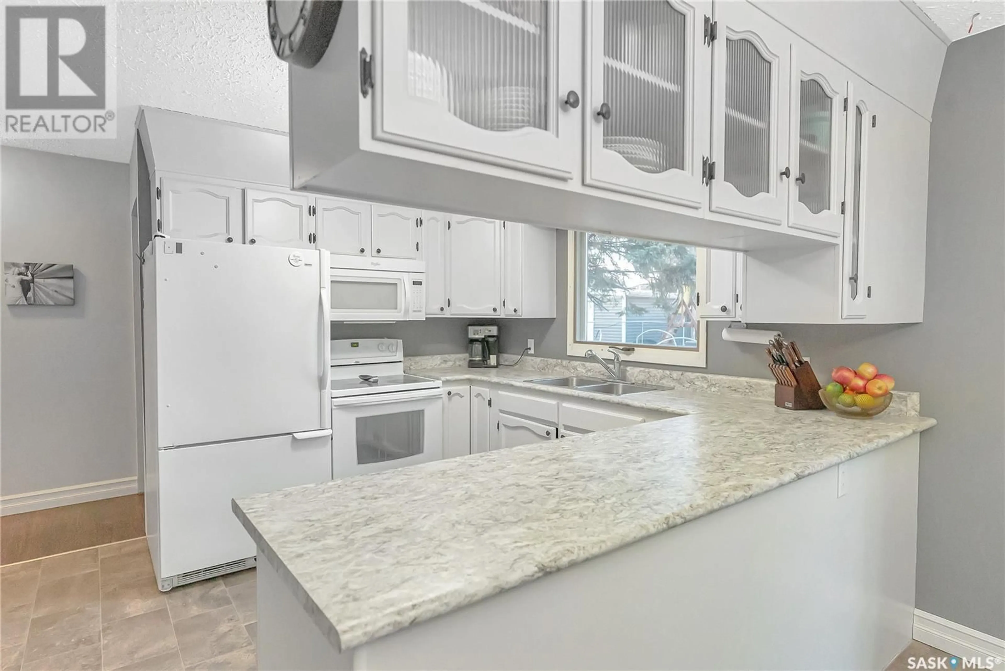 Open concept kitchen, ceramic/tile floor for 9705 97TH DRIVE, North Battleford Saskatchewan S9A3K3