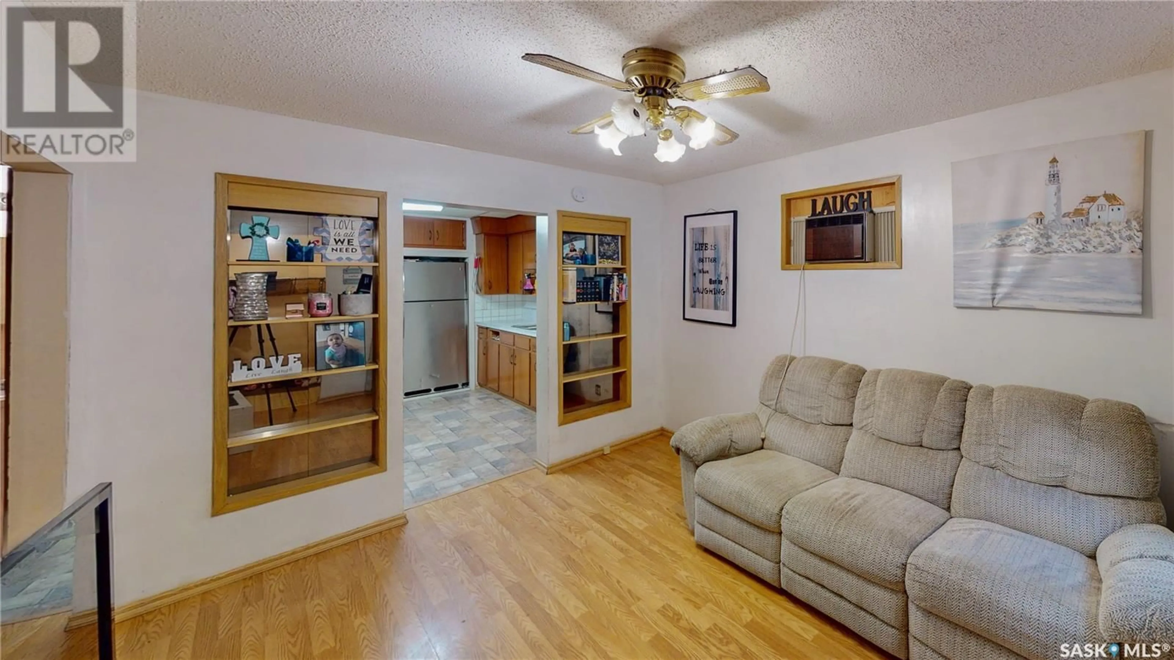 Living room with furniture, wood/laminate floor for 1425 McIntosh STREET, Regina Saskatchewan S4T5C4