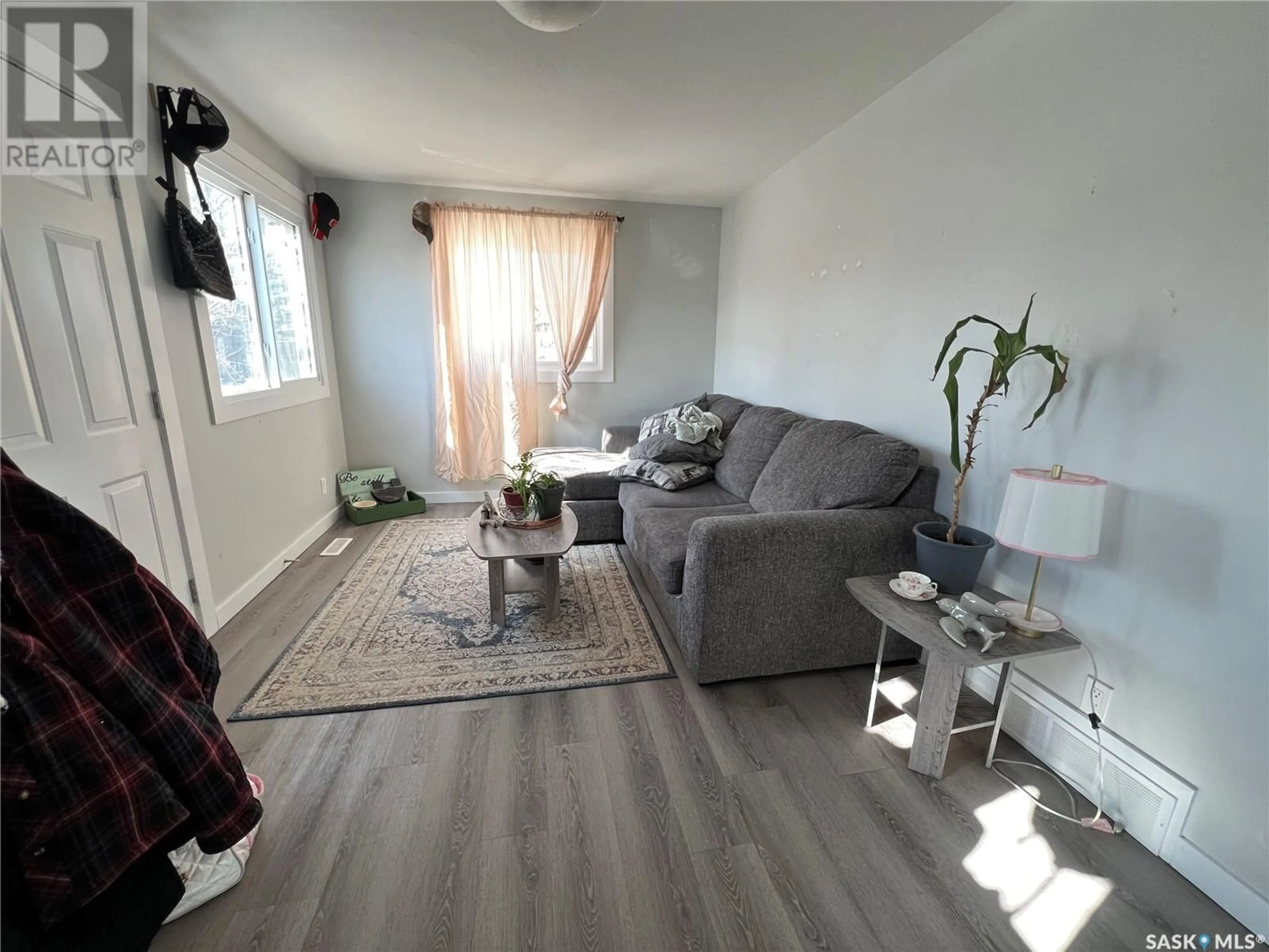 Living room with furniture, wood/laminate floor for 740 Weldon AVENUE, Saskatoon Saskatchewan S7M2V2