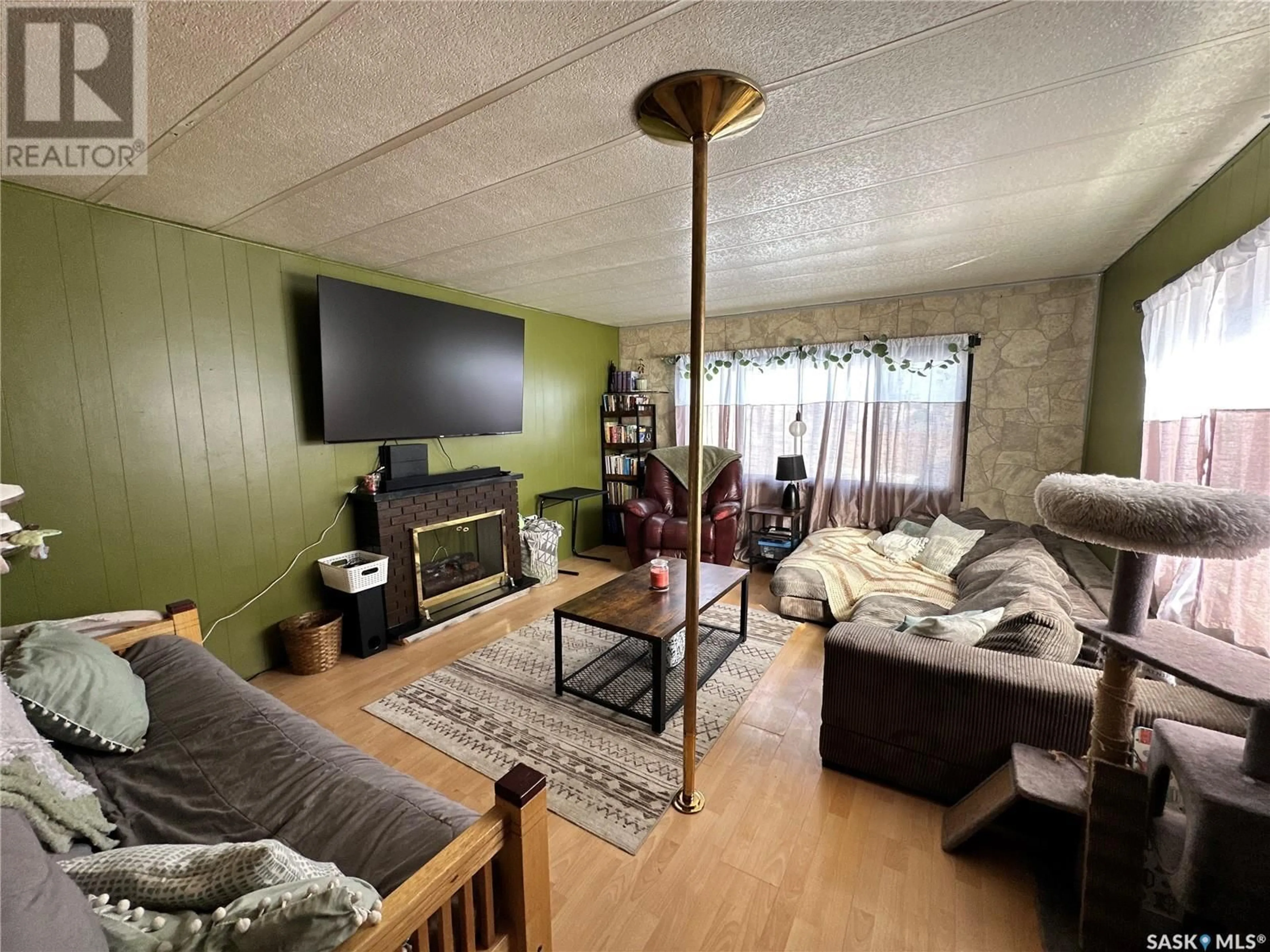 Living room with furniture, wood/laminate floor for 16 Prairie Sun COURT, Swift Current Saskatchewan S9H3X6