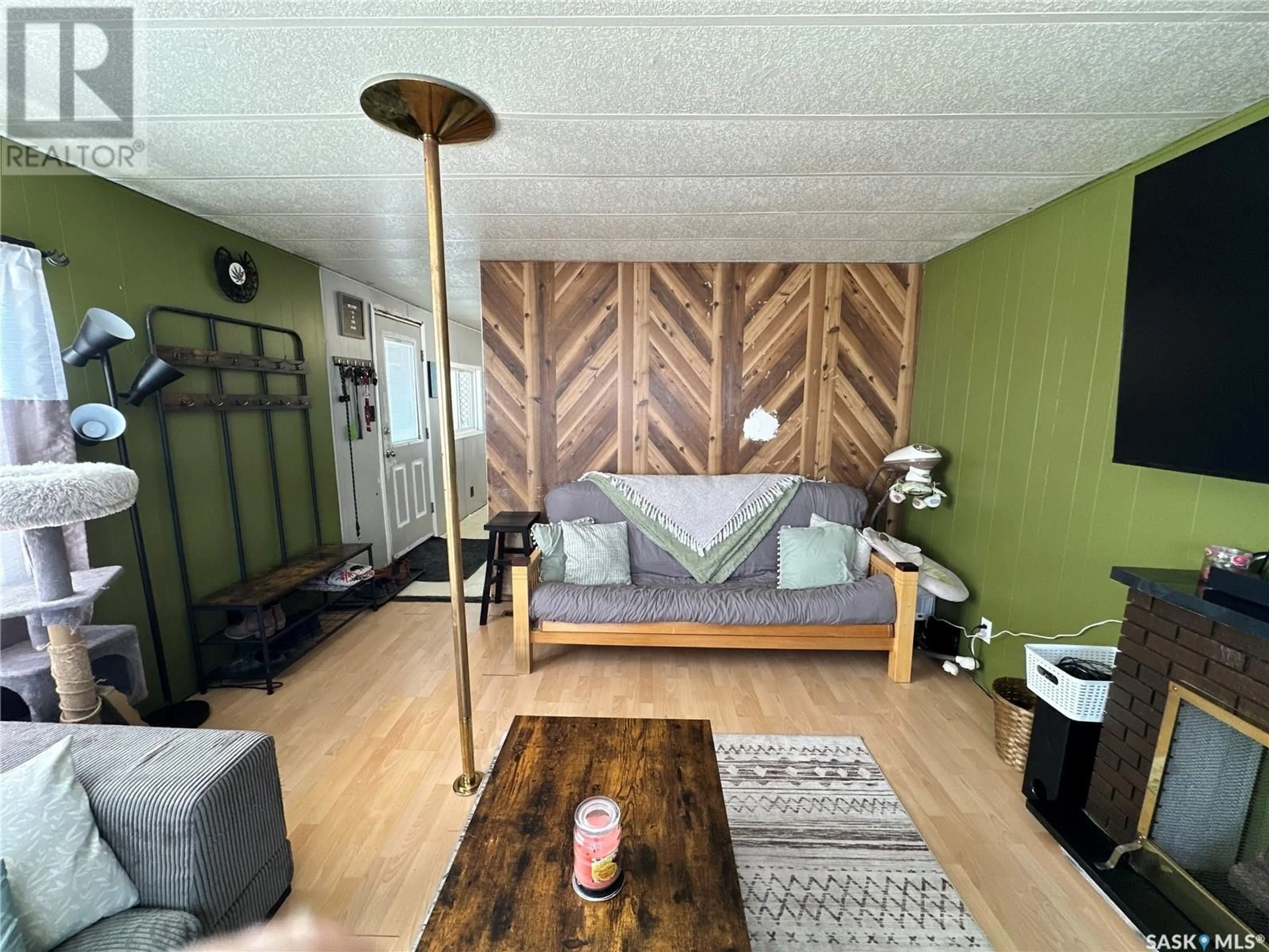 Living room with furniture, wood/laminate floor for 16 Prairie Sun COURT, Swift Current Saskatchewan S9H3X6