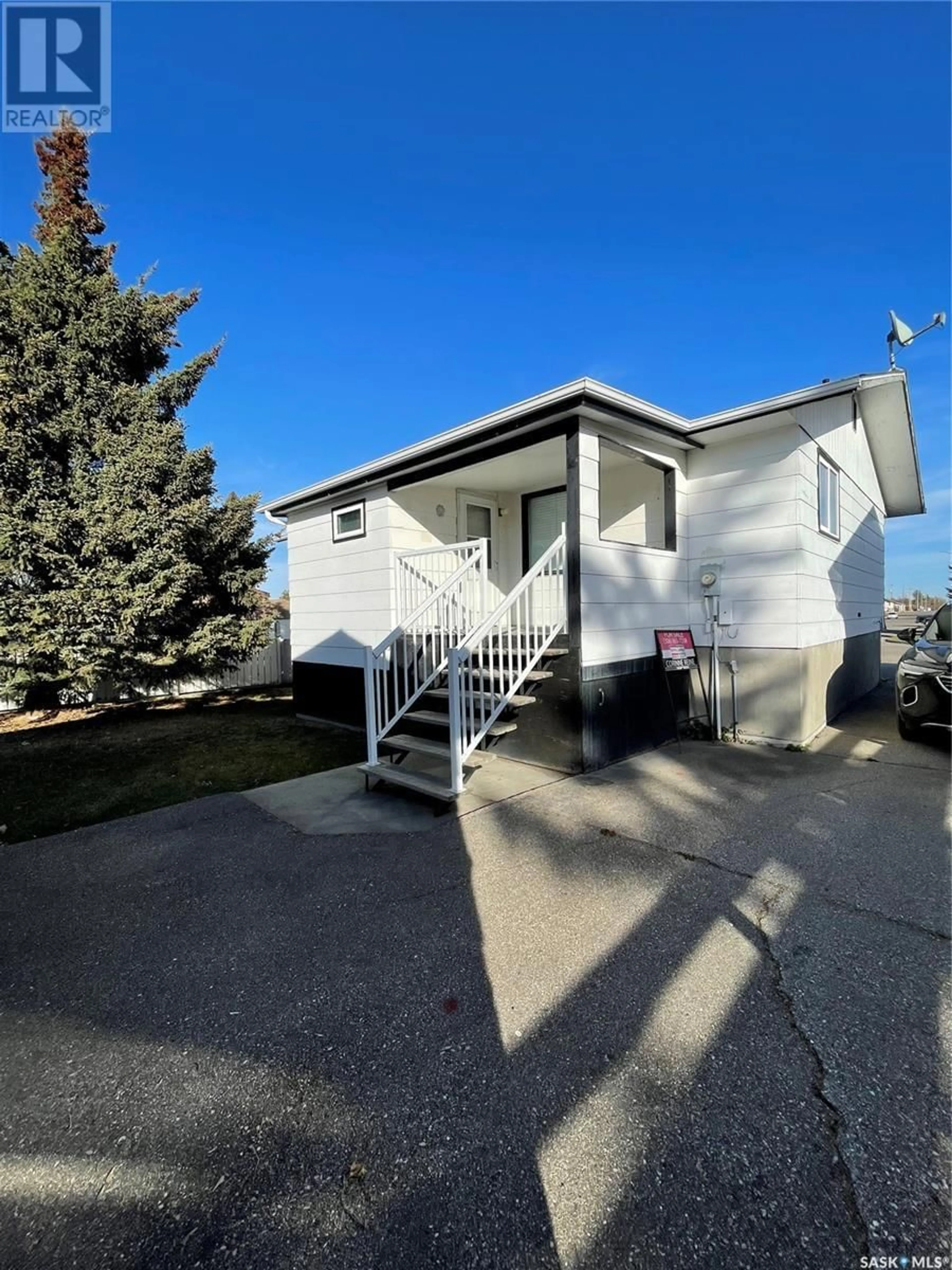 Home with vinyl exterior material, street for 701 Hudson CRESCENT, Hudson Bay Saskatchewan S0E0Y0