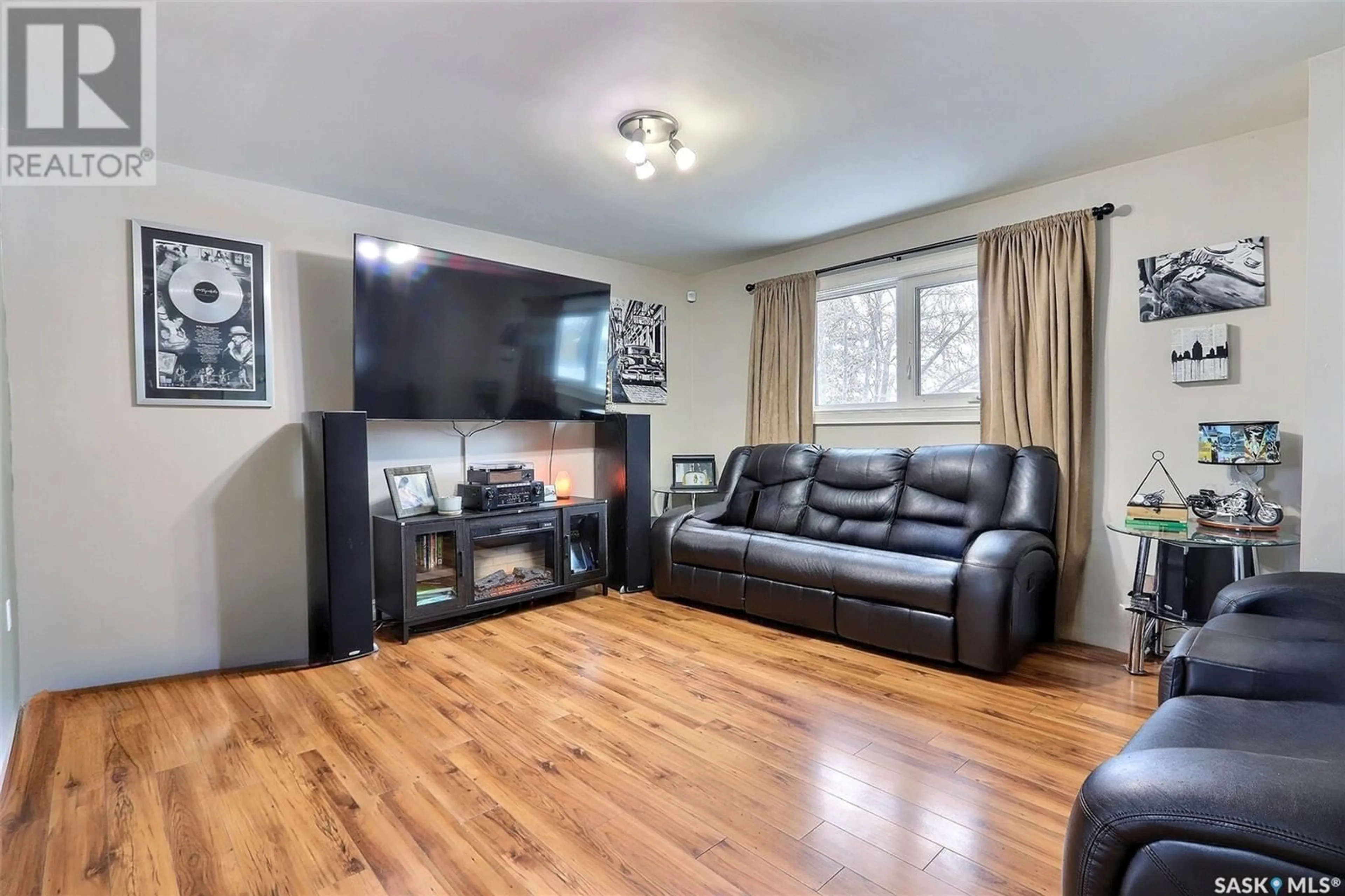 Living room with furniture, wood/laminate floor for 1168 3rd STREET E, Prince Albert Saskatchewan S6V0J6