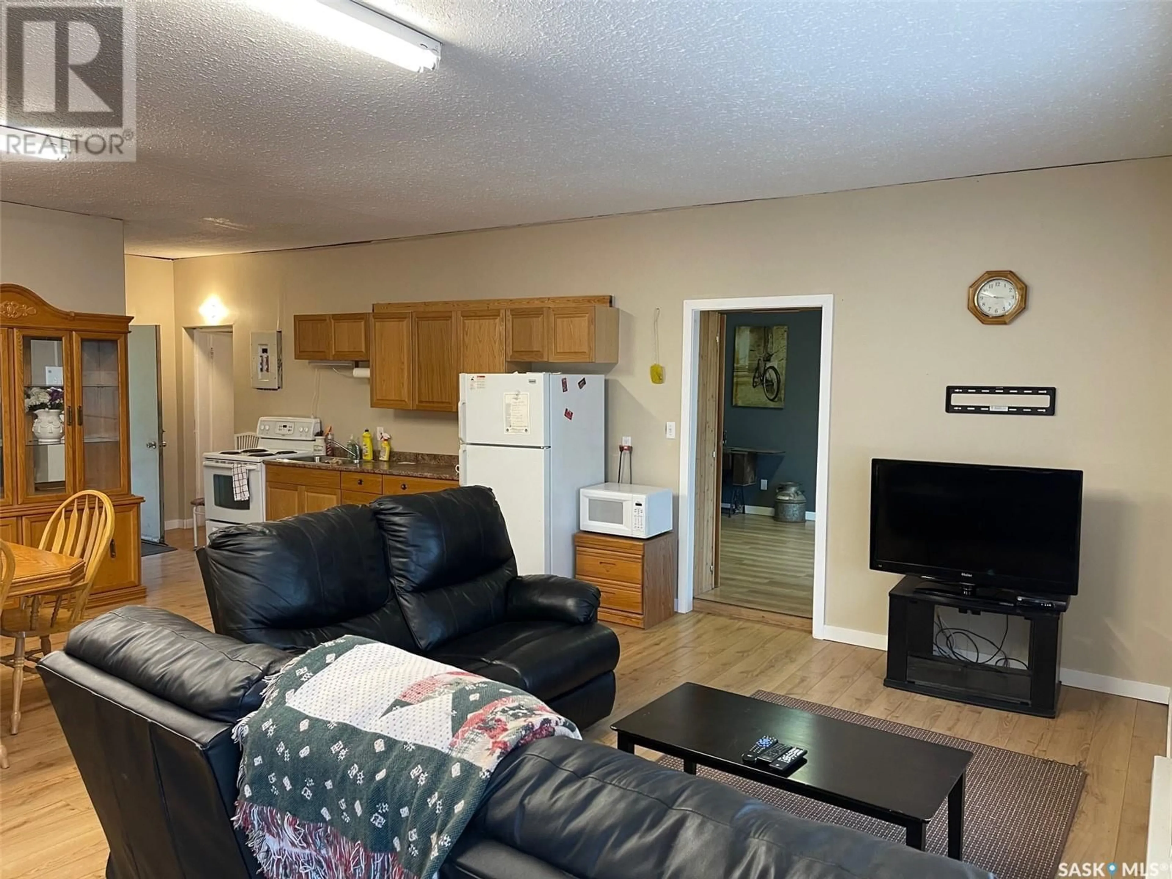 Living room with furniture, wood/laminate floor for 209 PINE STREET, Chitek Lake Saskatchewan S0J0L0