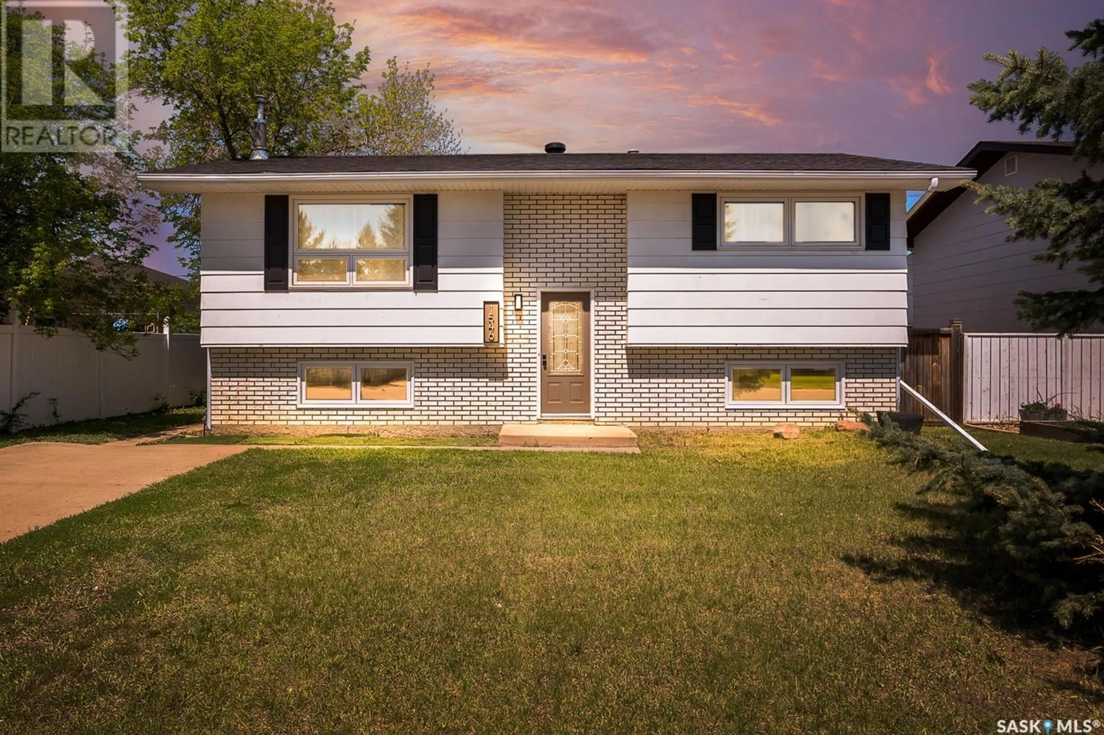 Home with vinyl exterior material, street for 1546 WARNER STREET, Moose Jaw Saskatchewan S6H5G3