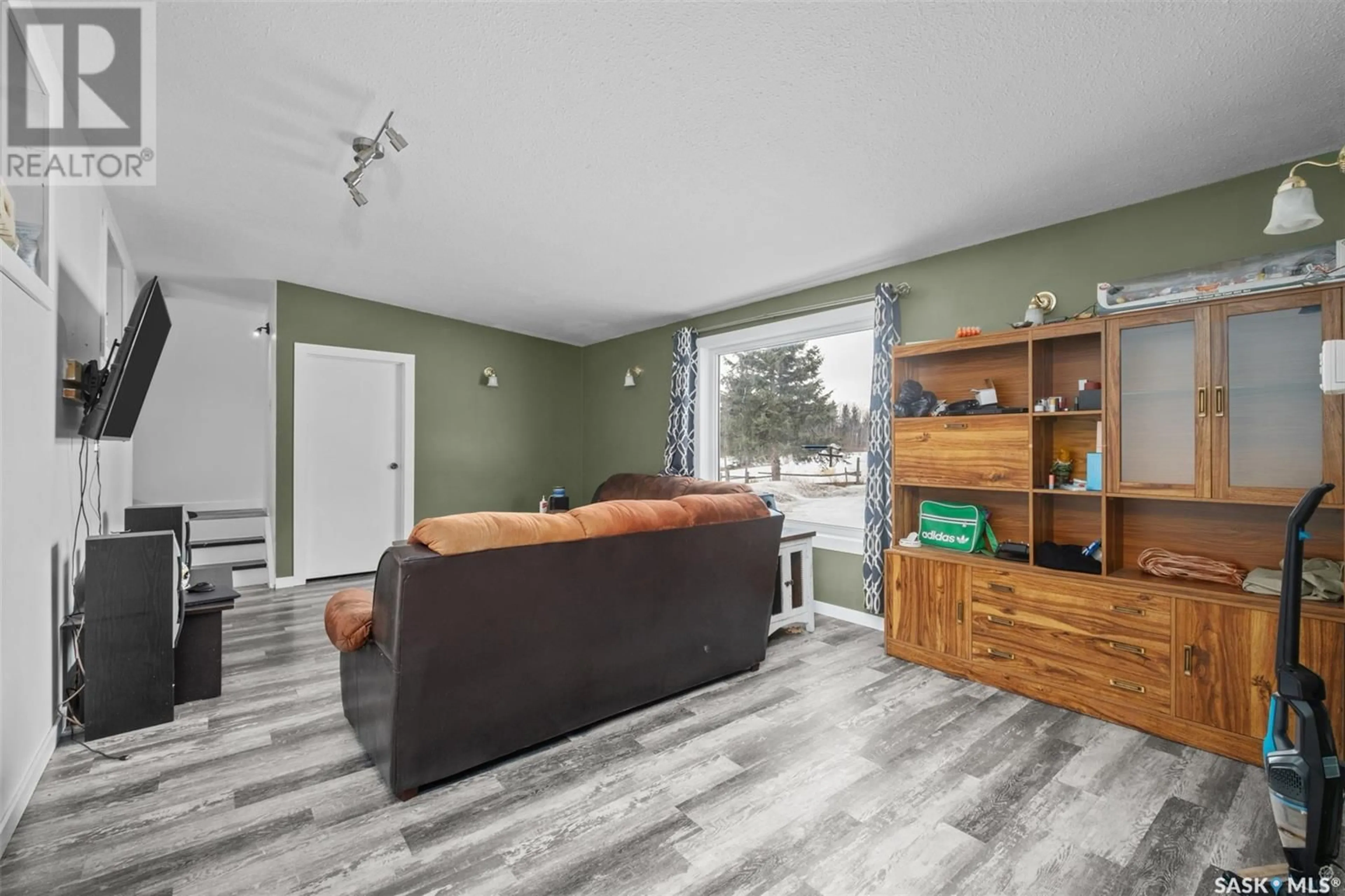 Living room with furniture, wood/laminate floor for CHRISTOPHER LAKE ACREAGE, Paddockwood Rm No. 520 Saskatchewan S0J0N0