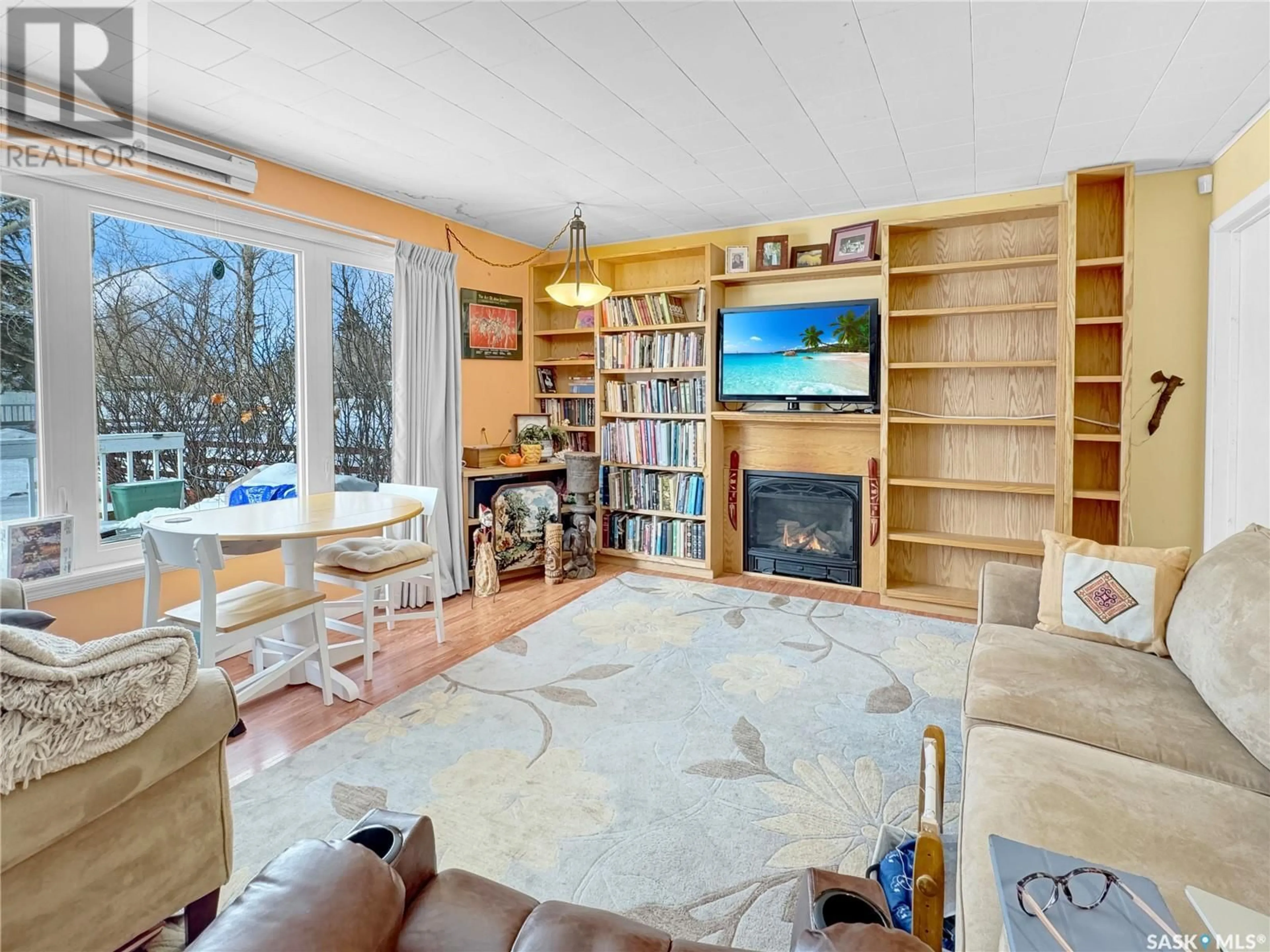 Living room with furniture, wood/laminate floor for 9162 DONALD CRESCENT, Cochin Saskatchewan S0M0L0
