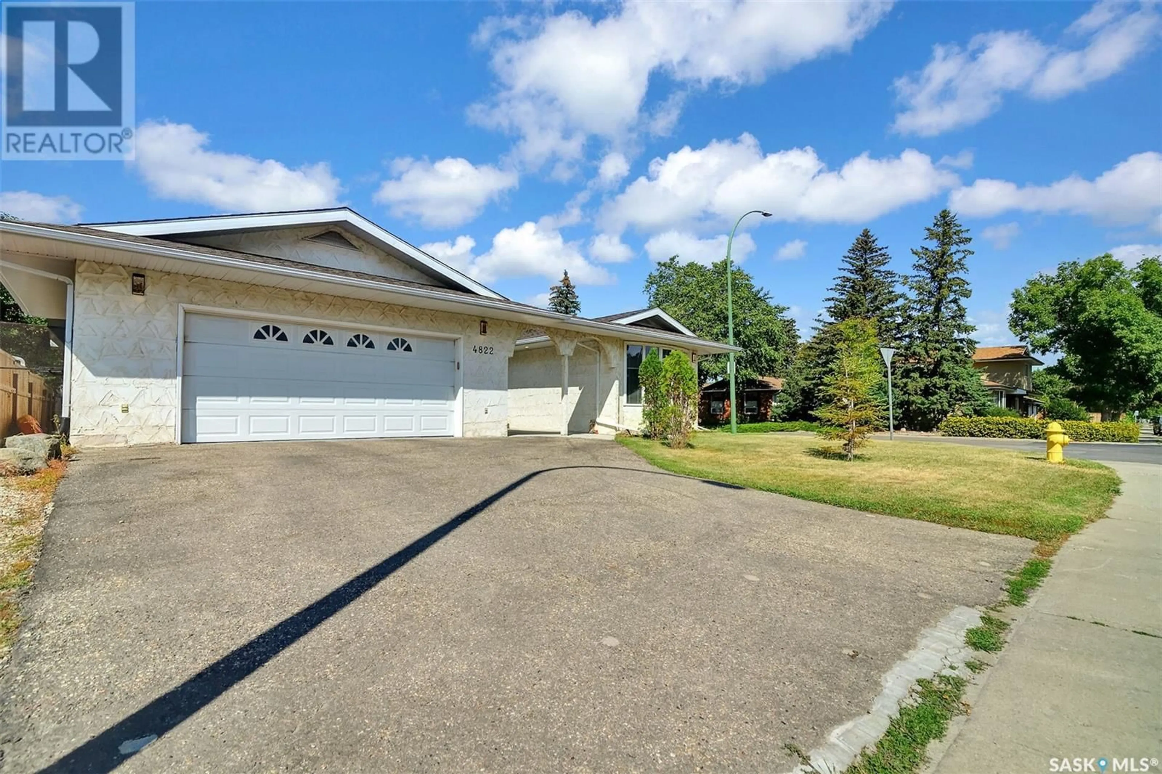 Home with vinyl exterior material, street for 4822 QUEEN STREET, Regina Saskatchewan S4S6V8