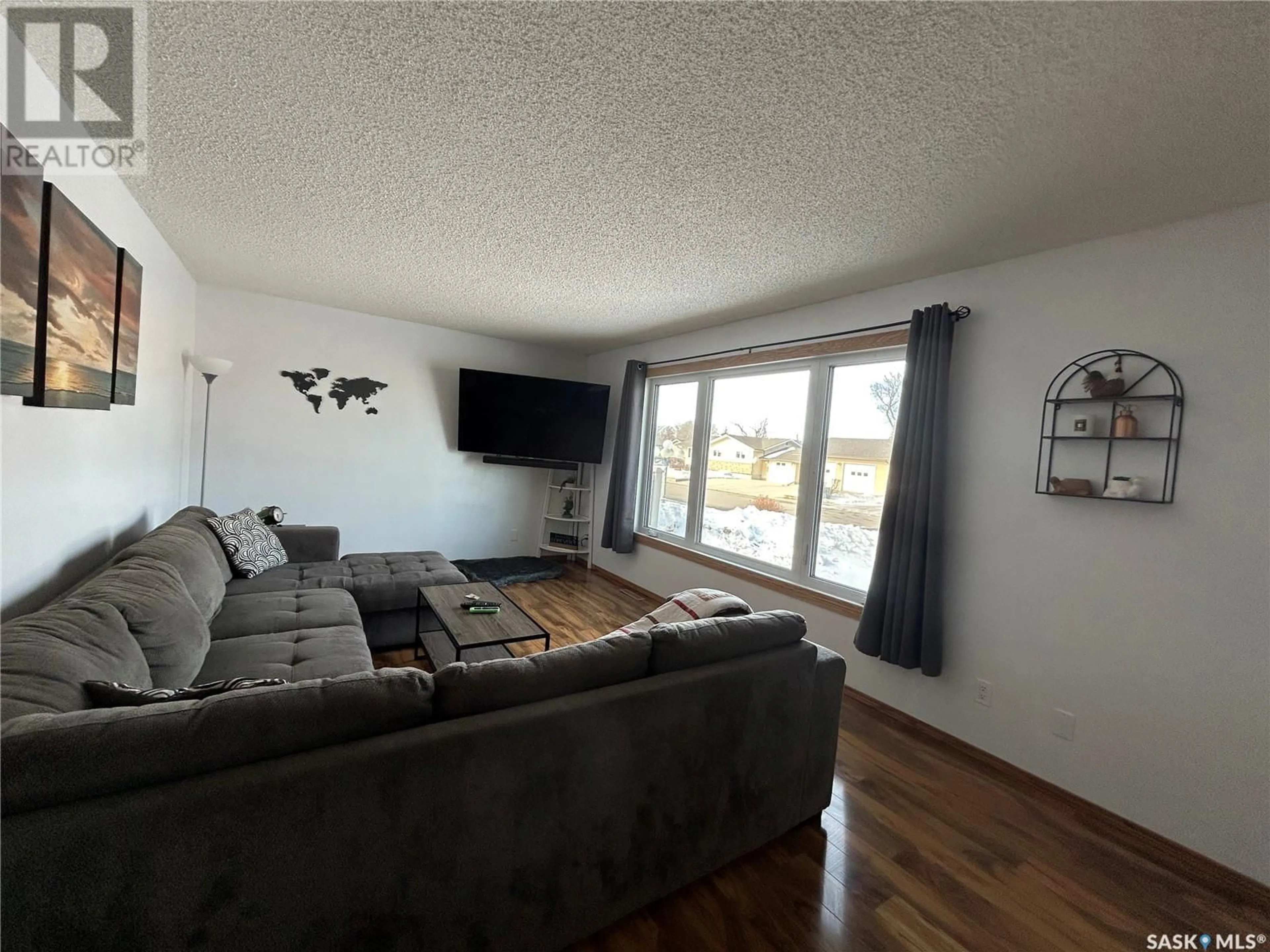 Living room with furniture, wood/laminate floor for 854 SMITH STREET, Estevan Saskatchewan S4A1J9