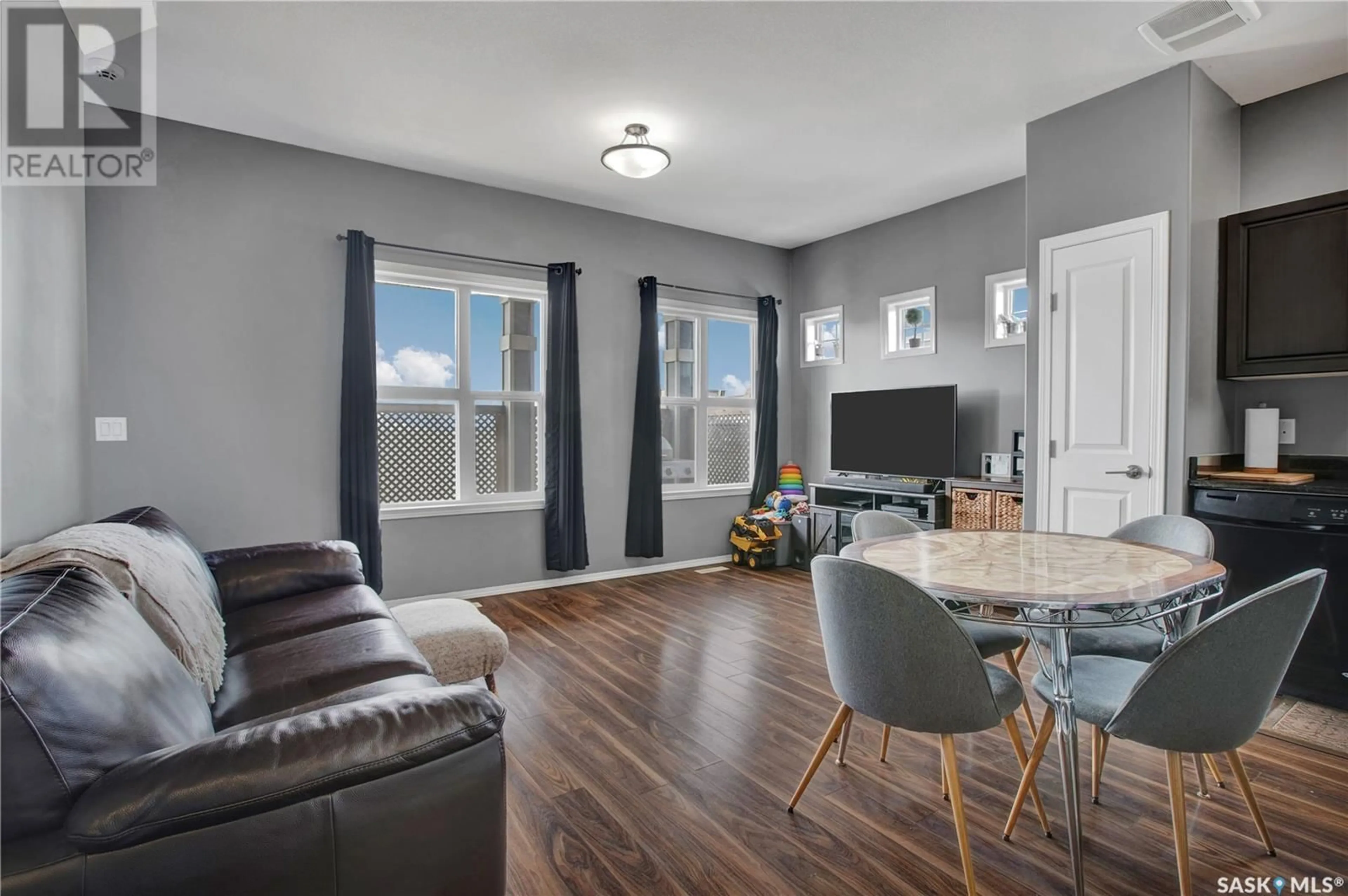 Living room with furniture, wood/laminate floor for 402 100 CHAPARRAL BOULEVARD, Martensville Saskatchewan S0K0A2