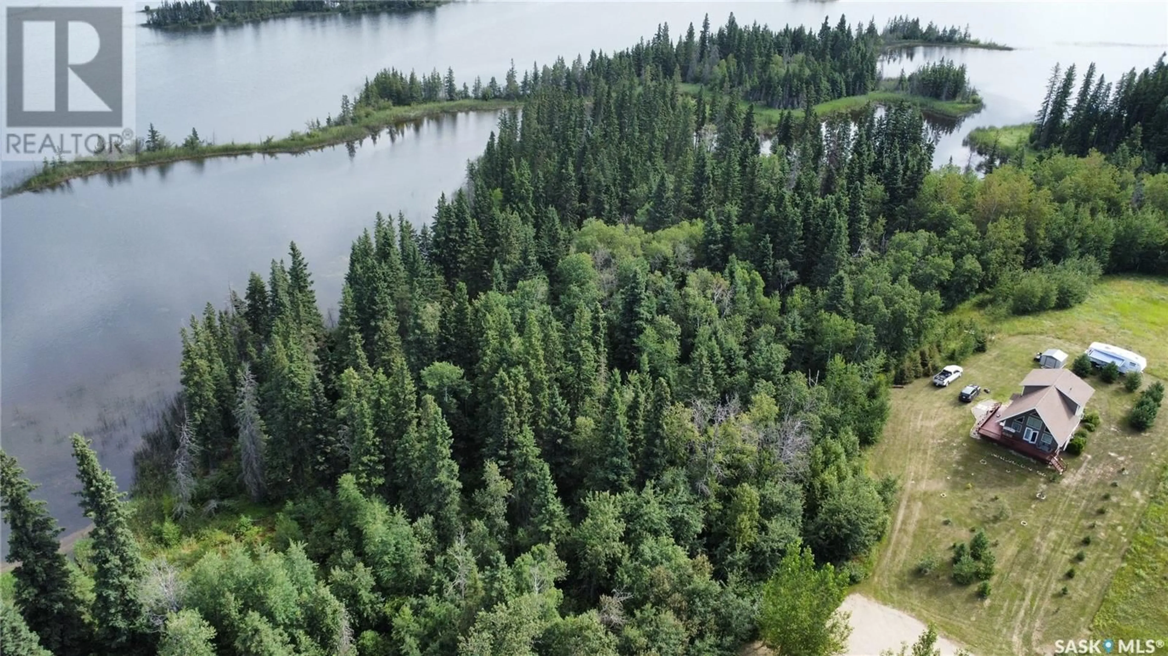 A pic from outside/outdoor area/front of a property/back of a property/a pic from drone, forest/trees view for 13 JADE LANE, Shell Lake Saskatchewan S0J2G0