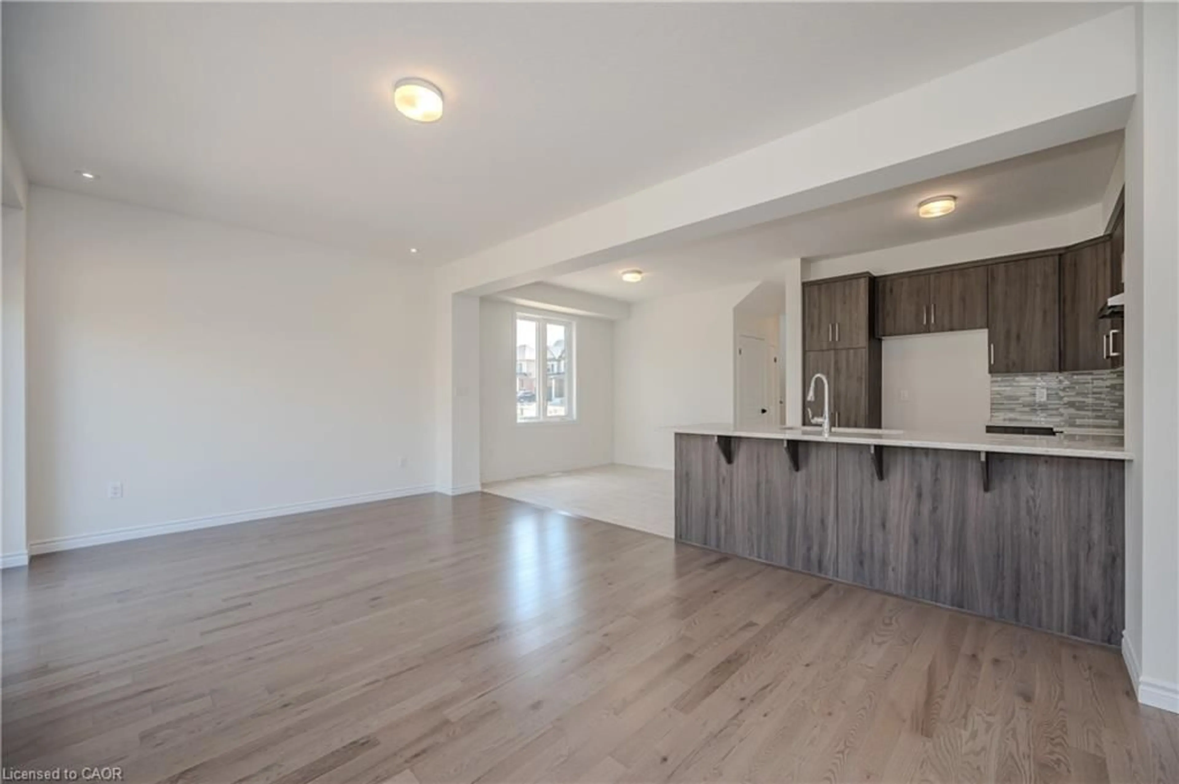 Open concept kitchen, wood/laminate floor for 298 Robert Woolner St, Ayr Ontario N0B 1E0