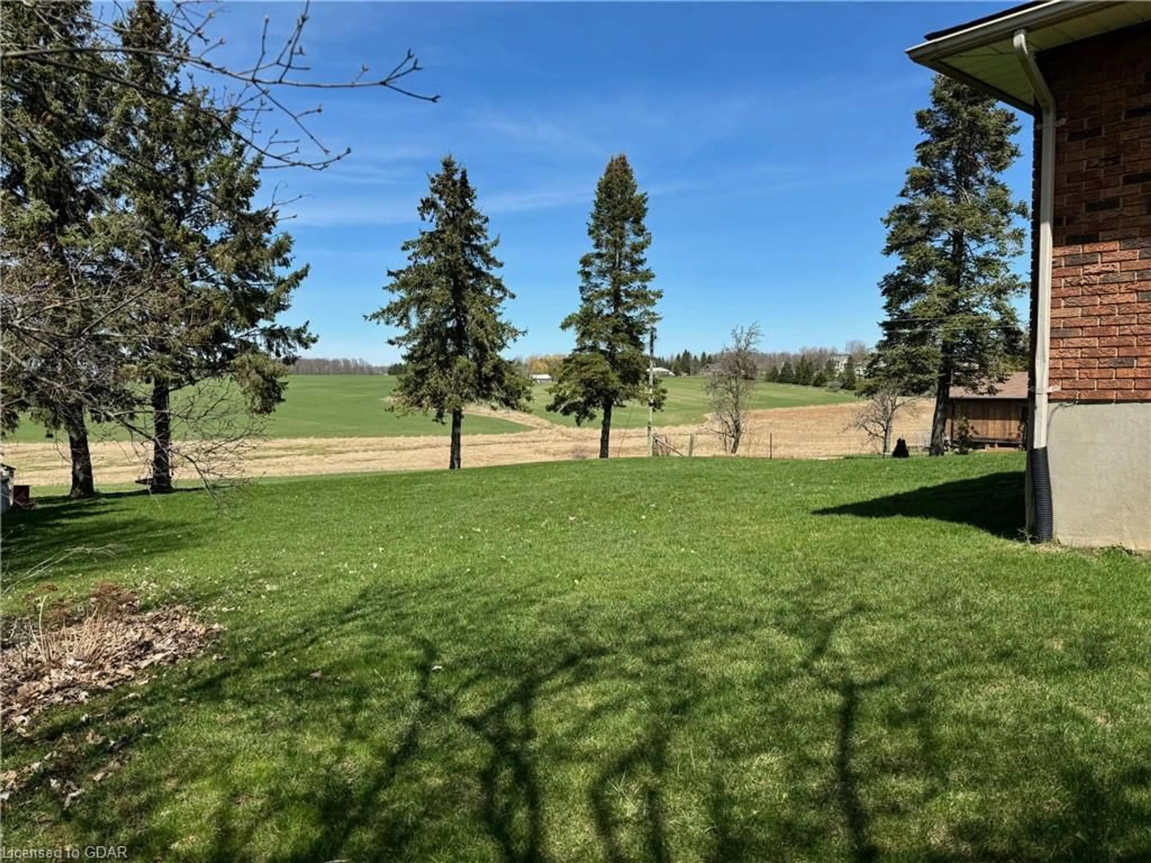 A pic from exterior of the house or condo, the fenced backyard for 7680 Eighth Line, Guelph Ontario N1H 6J2