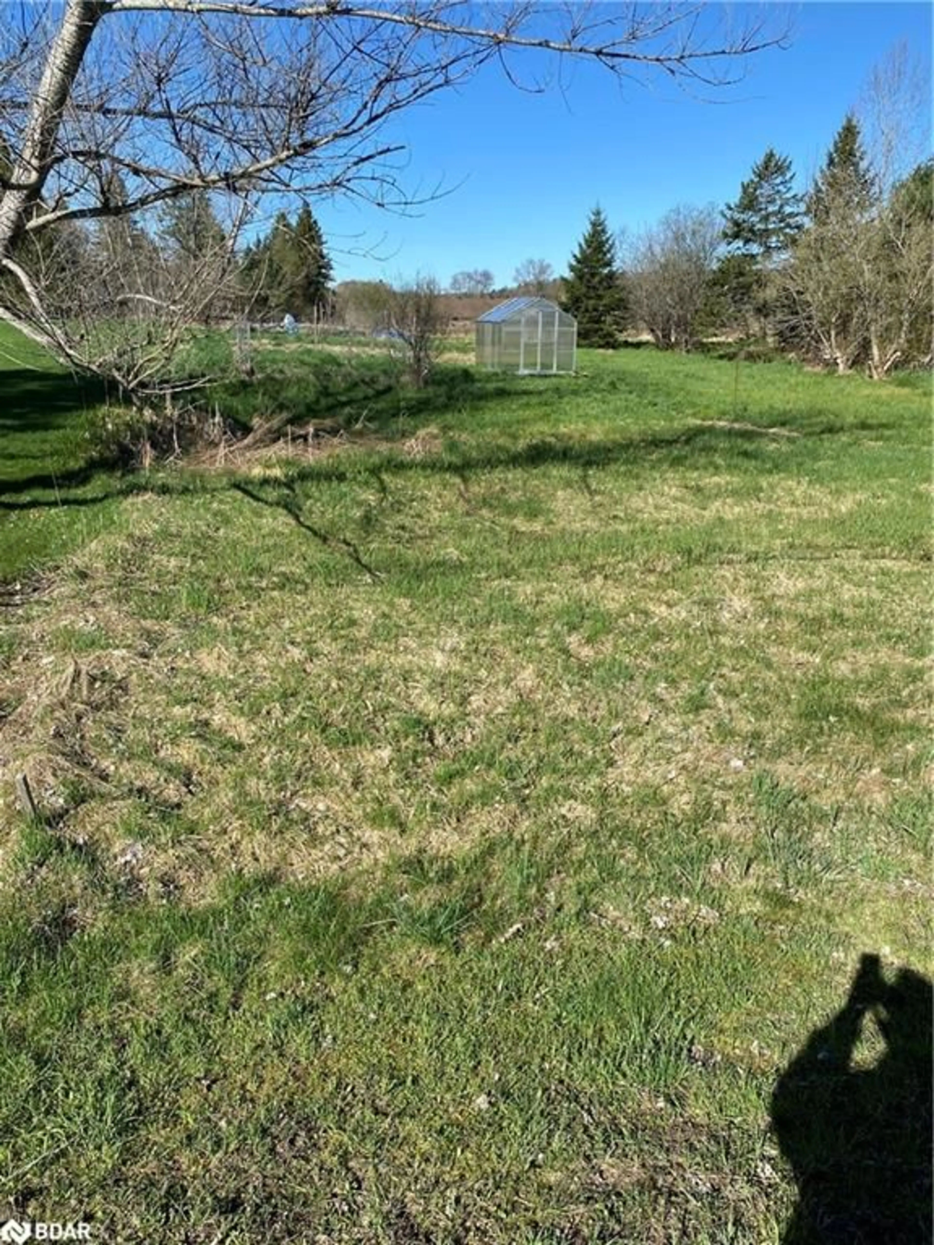 Frontside or backside of a home, the fenced backyard for 68 South Sparks St, Hagerman Ontario P0A 1P0