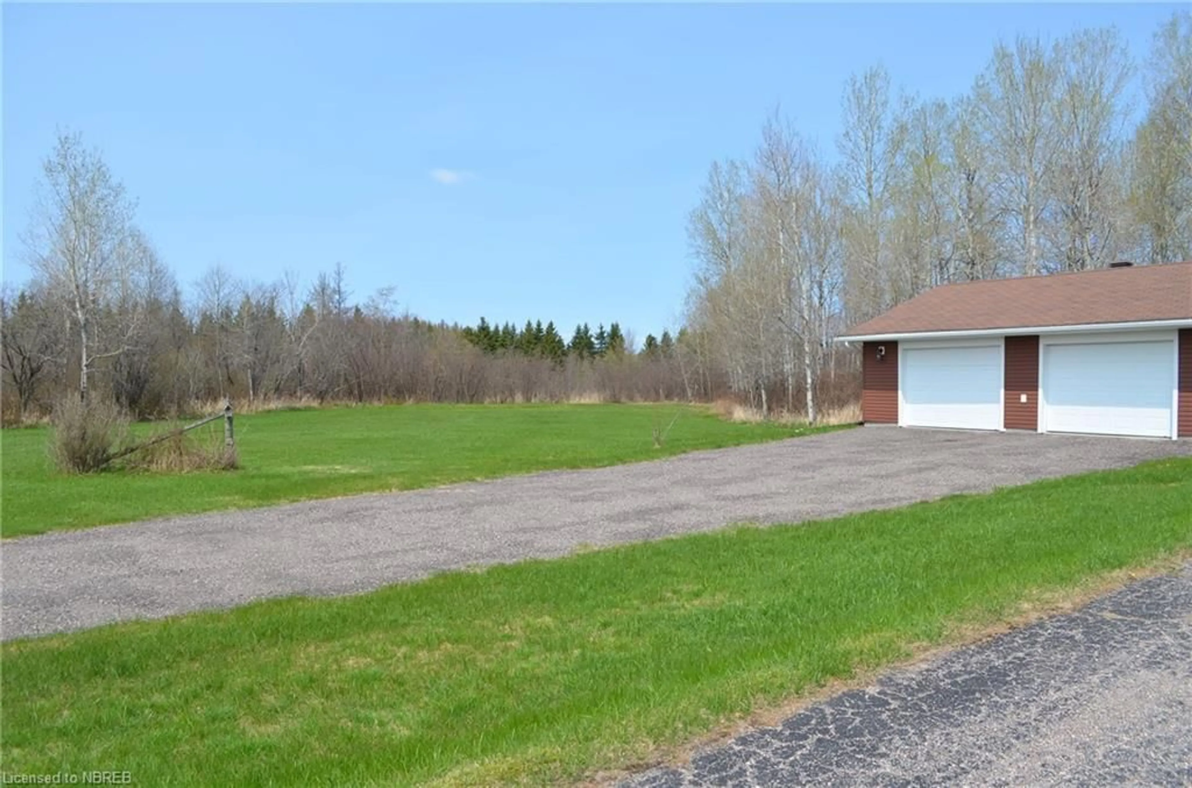 Frontside or backside of a home, the fenced backyard for 492 Mccarthy St, Trout Creek Ontario P0H 2L0