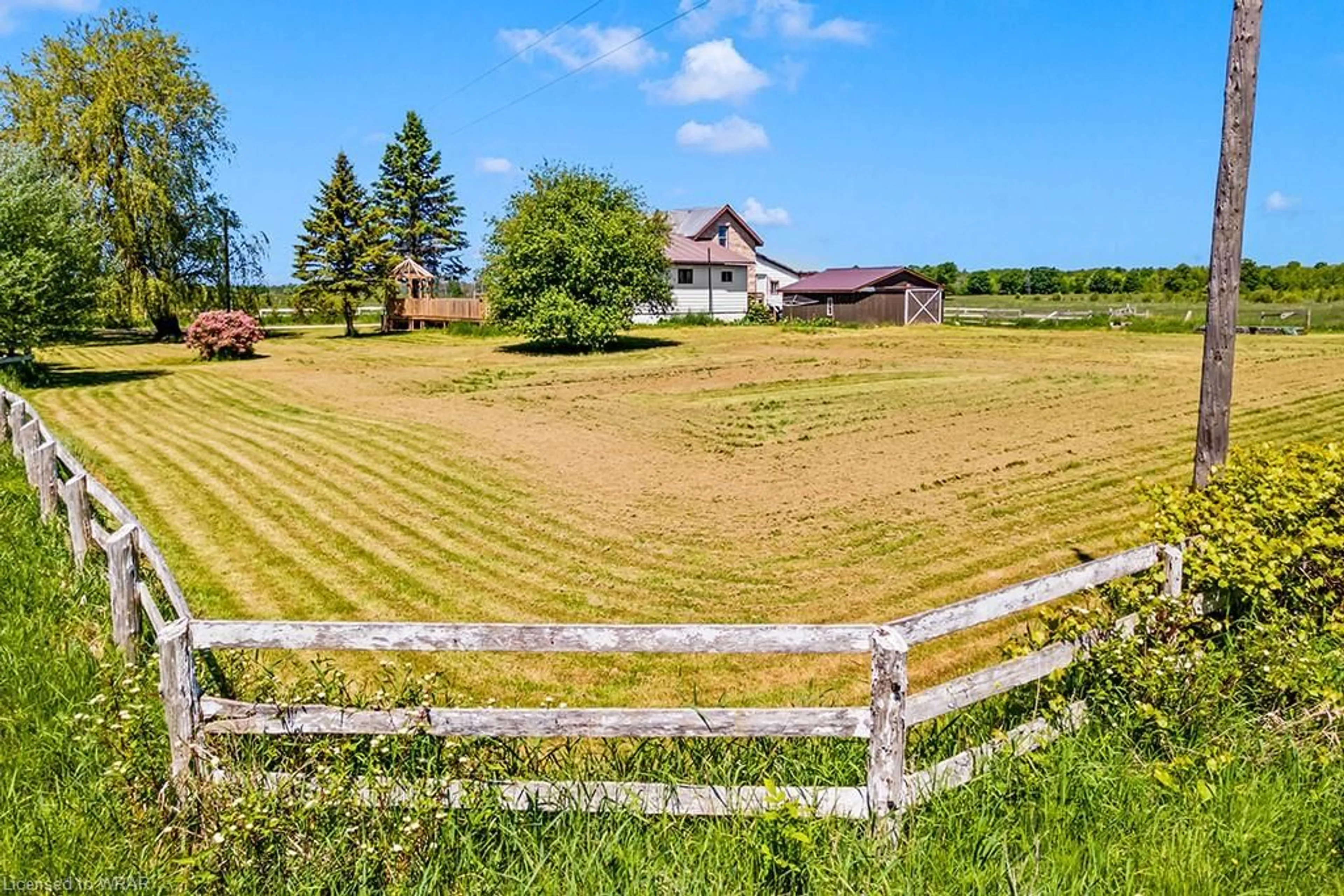 Frontside or backside of a home, the fenced backyard for 20 Elm St, Wiarton Ontario N0H 2T0