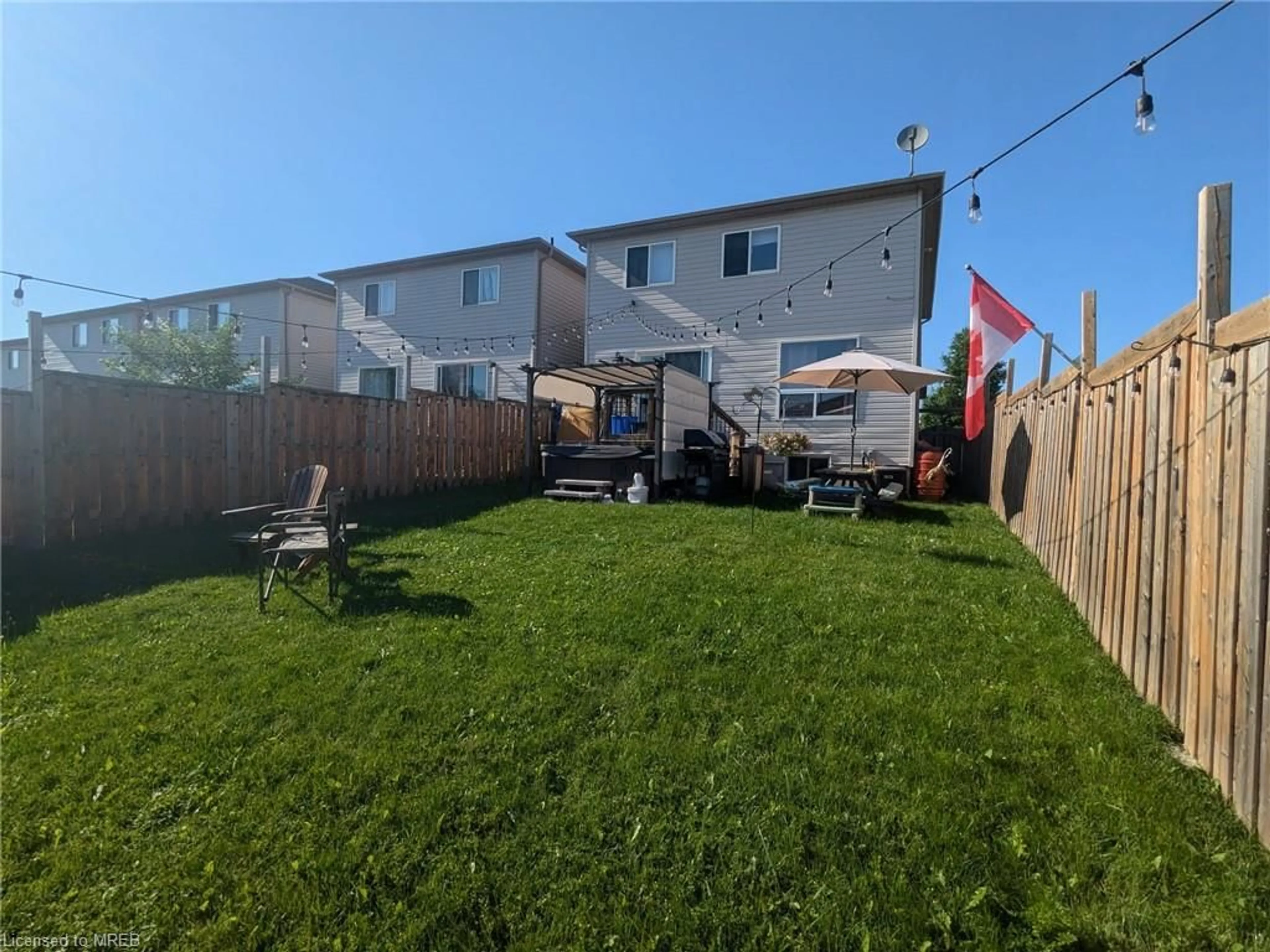 Frontside or backside of a home, the fenced backyard for 48 Dunsmore Lane, Barrie Ontario L4M 6Z9