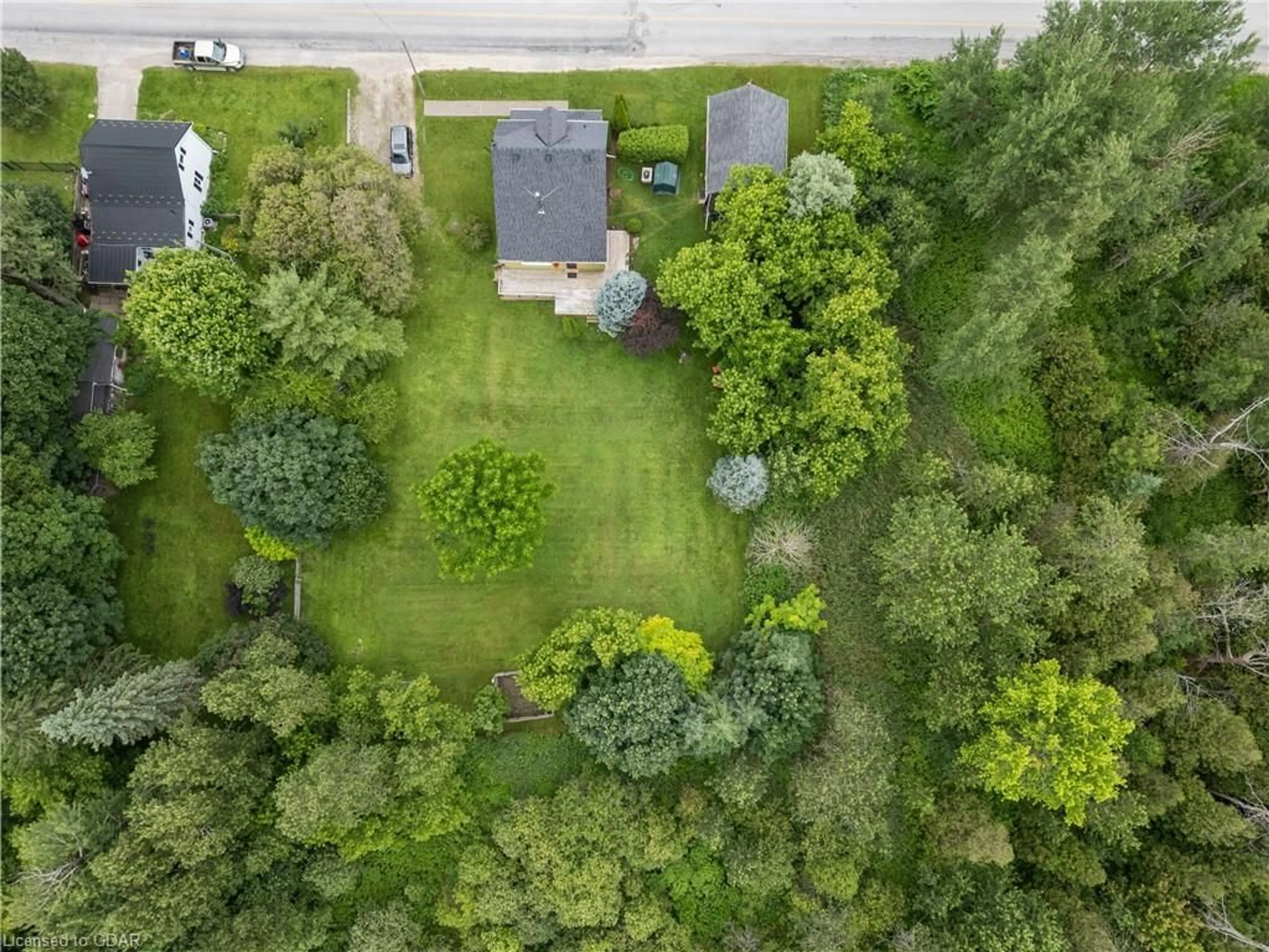 Frontside or backside of a home, the fenced backyard for 22021 East Garafraxa-Erin Tline, East Garafraxa Ontario L9W 7G4