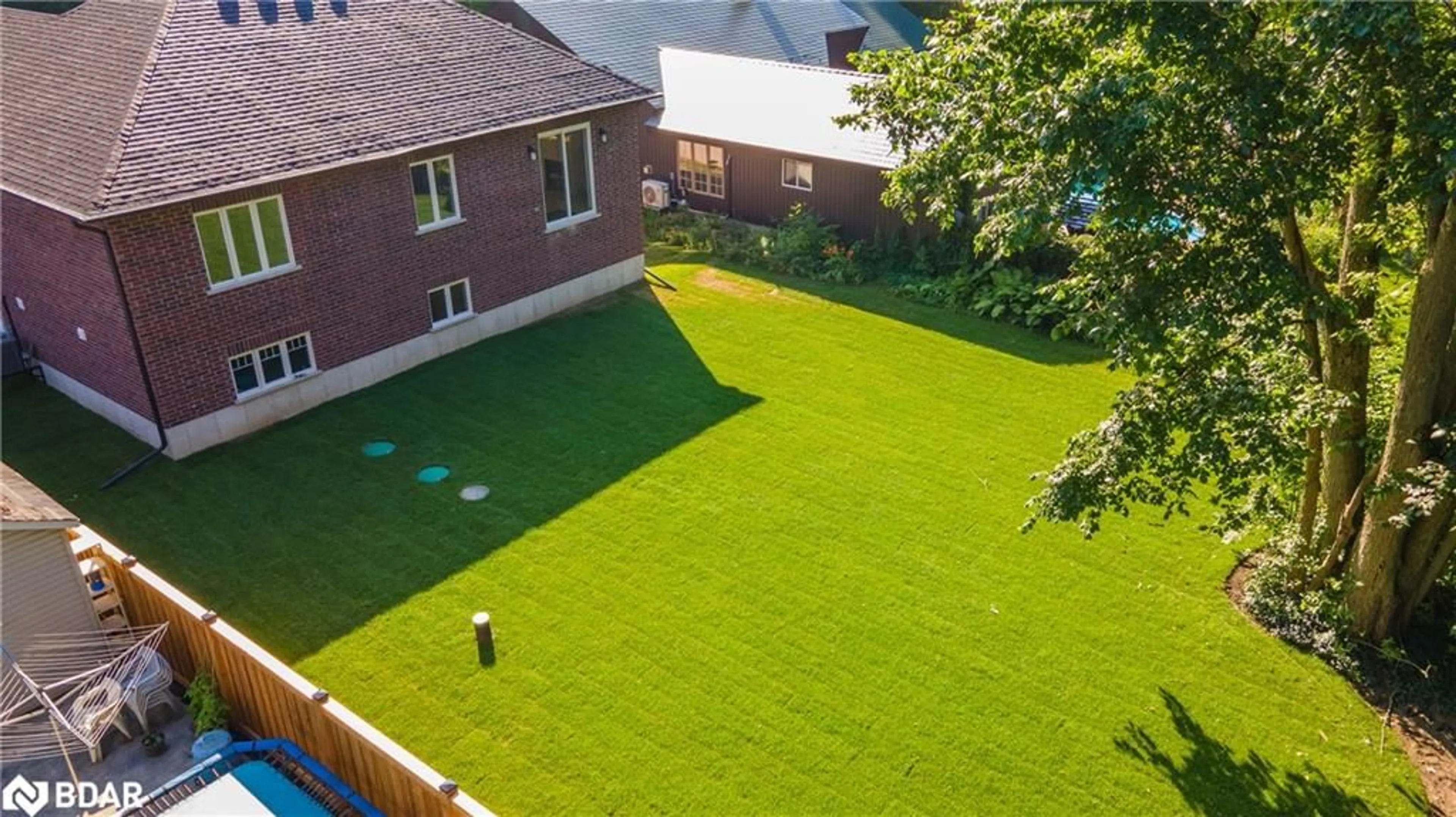 Frontside or backside of a home, the fenced backyard for 8 Alexander Street St, Minesing Ontario L3V 3T8