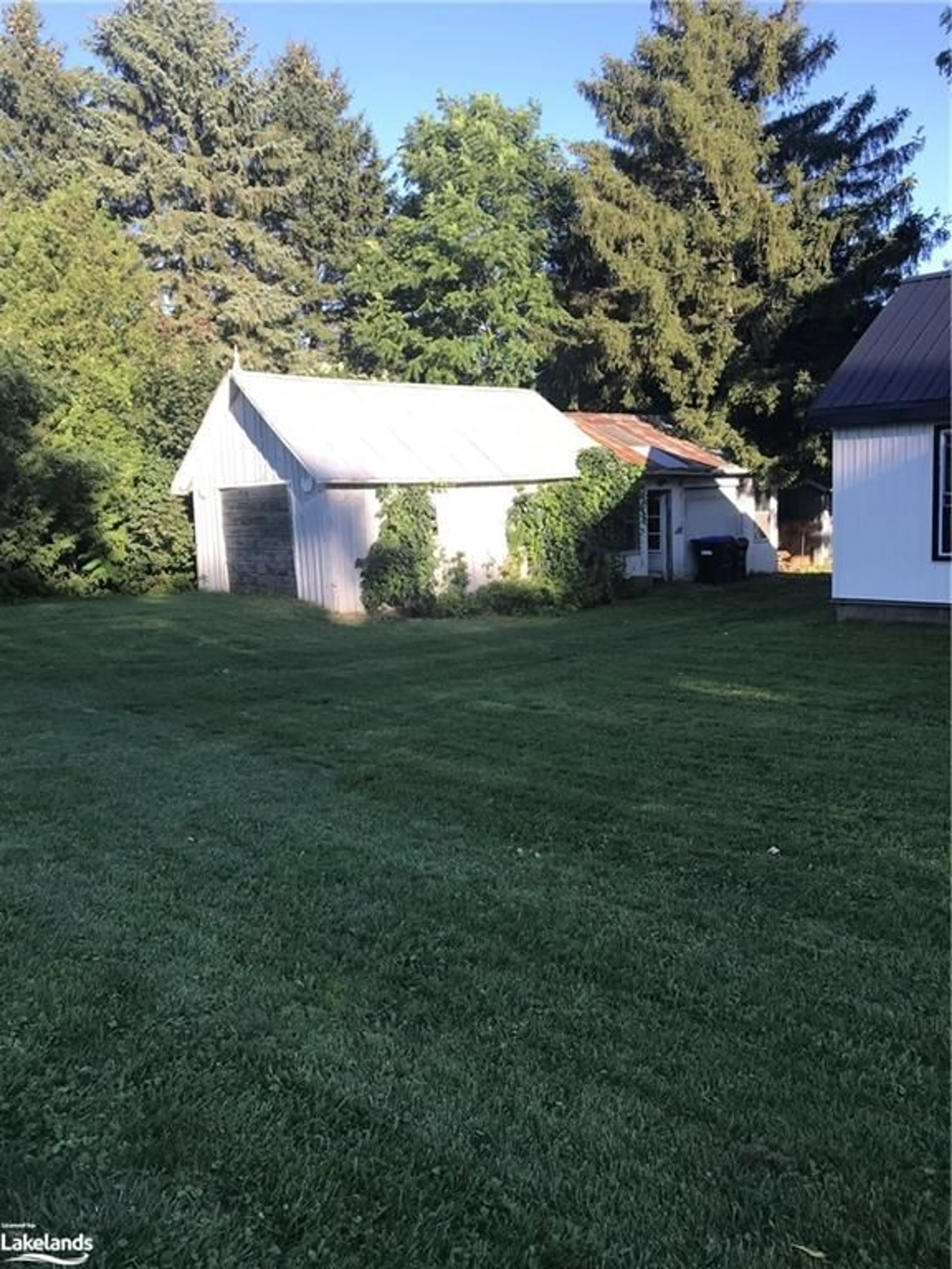 Frontside or backside of a home, the fenced backyard for 35 Caroline St, Creemore Ontario L0M 1G0