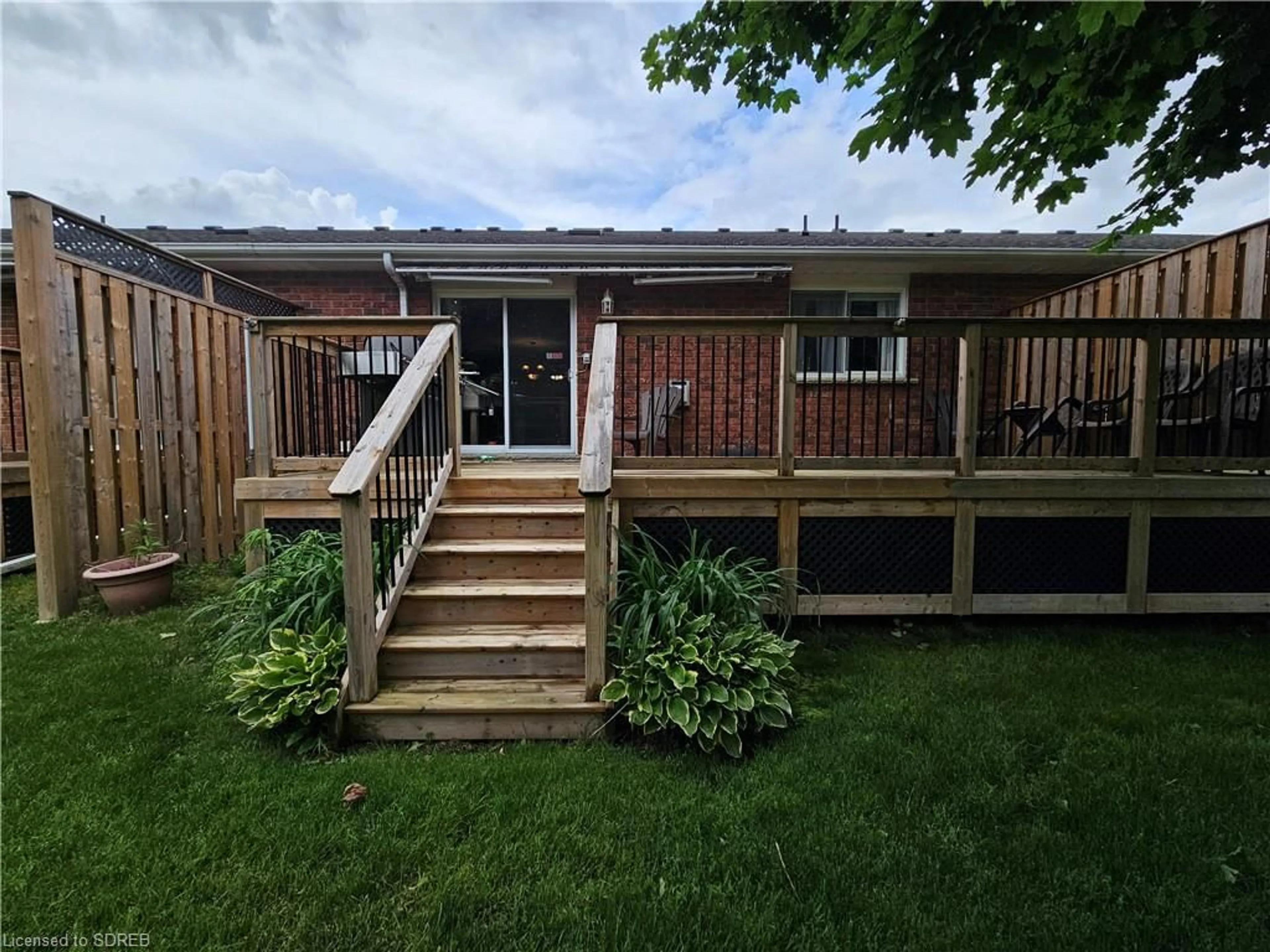 Frontside or backside of a home, the fenced backyard for 74 Wilson Ave #7, Delhi Ontario N4B 3E7