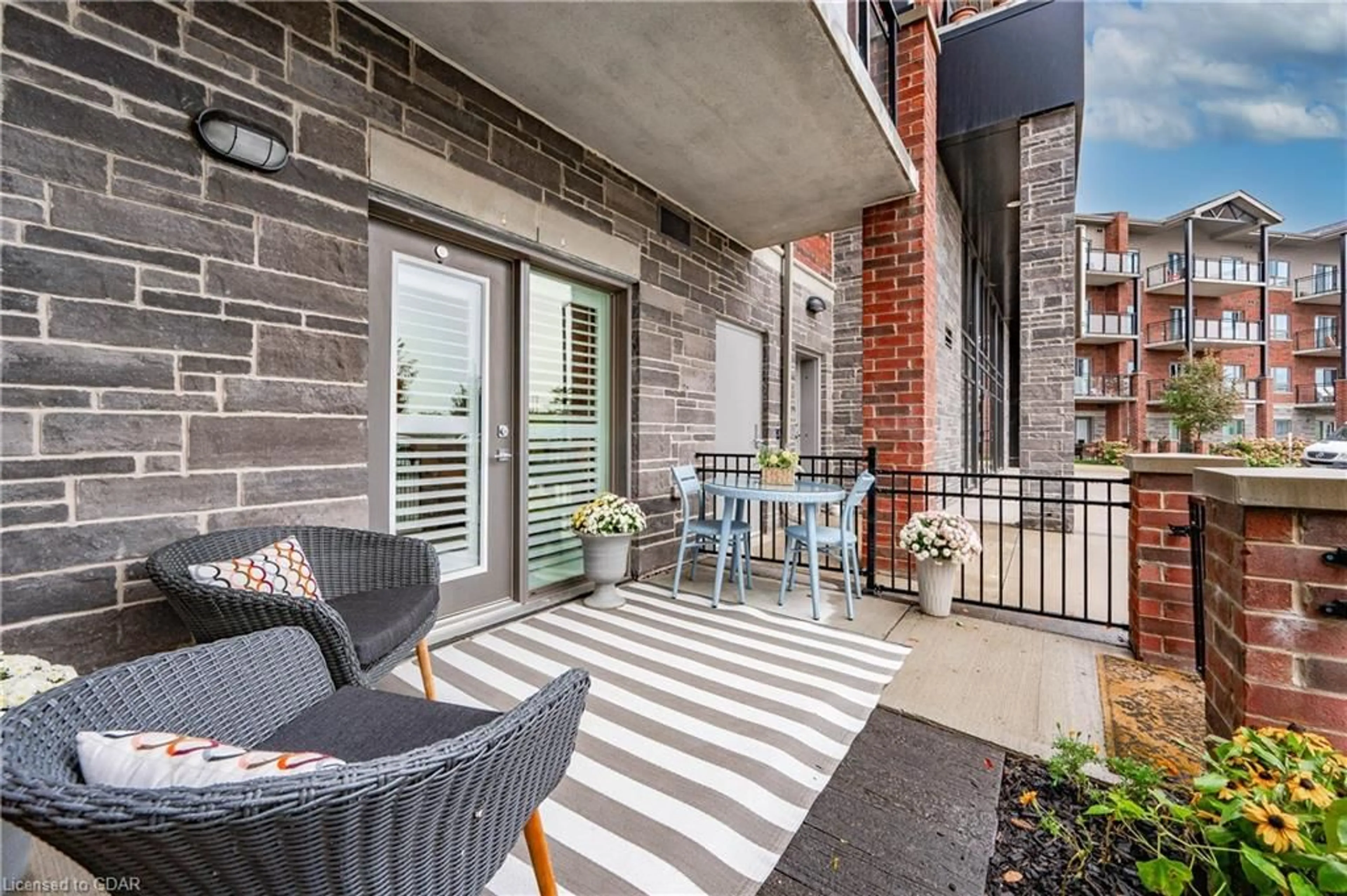 Patio, the fenced backyard for 35 Kingsbury Sq #109, Guelph Ontario N1L 0J4