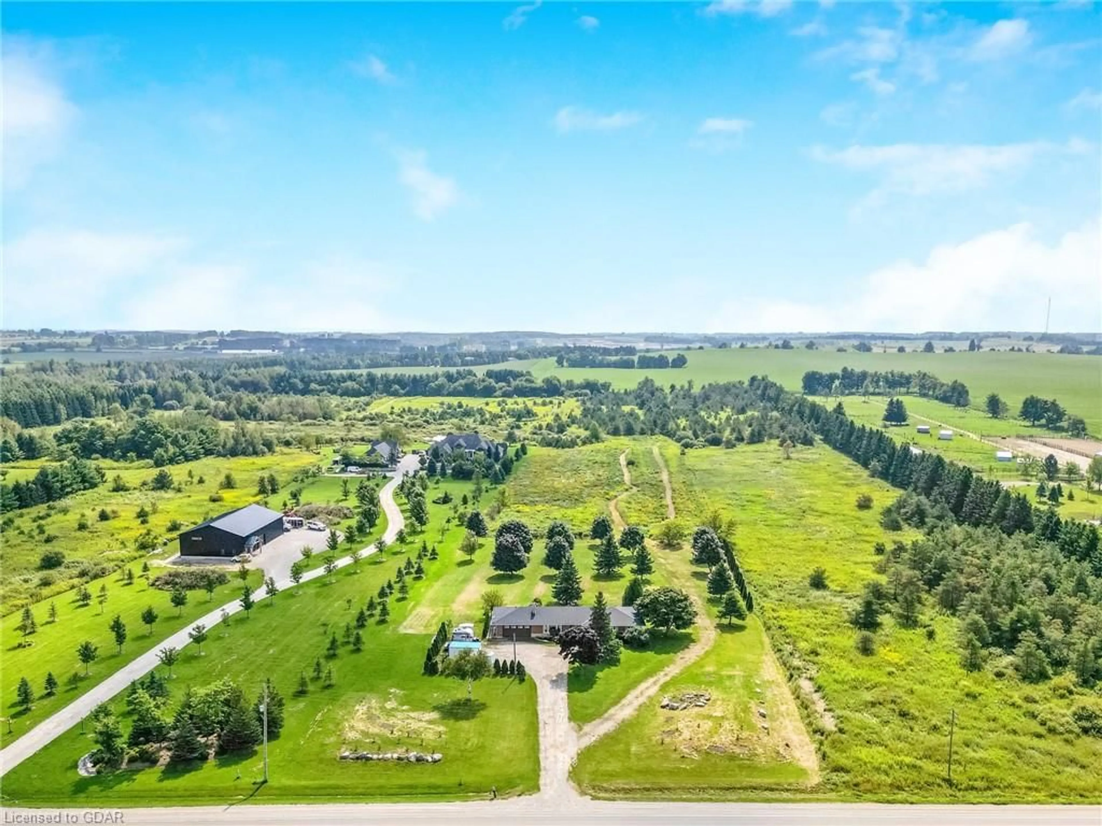 A pic from exterior of the house or condo, the fenced backyard for 064232 County Rd 3, East Garafraxa Ontario L9W 7J4