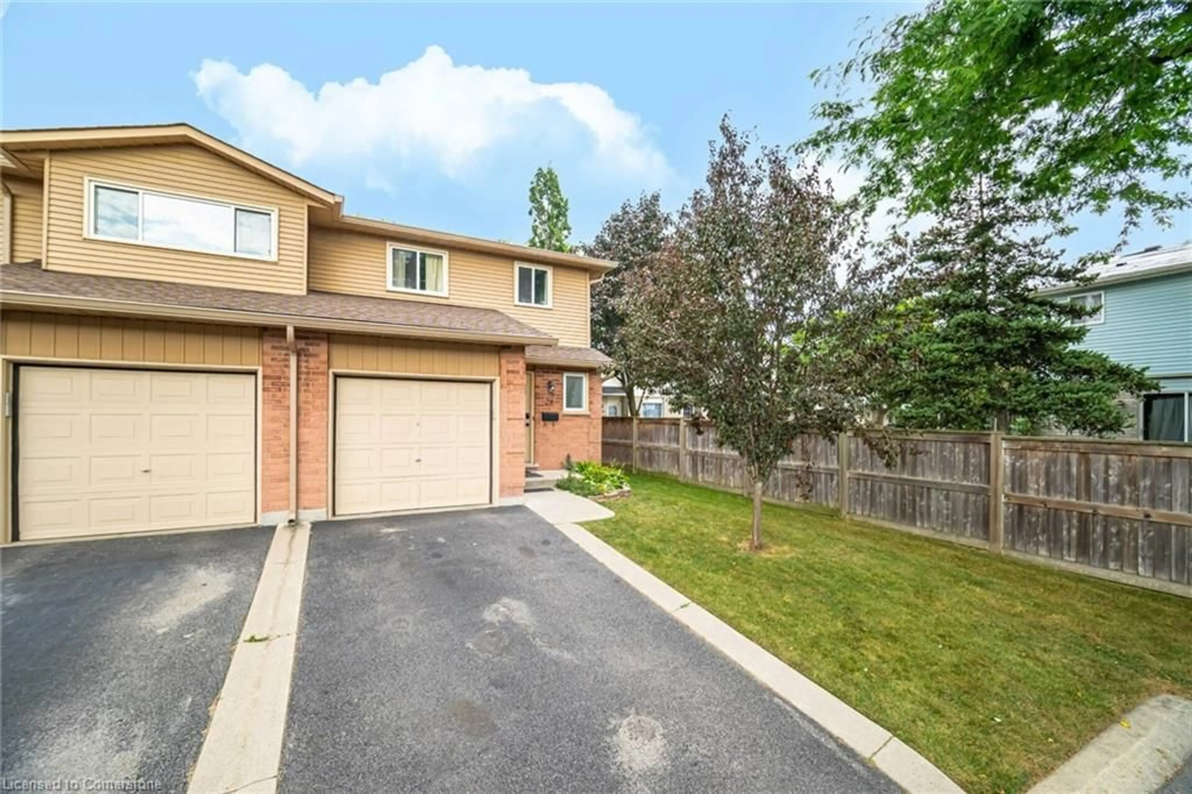 A pic from exterior of the house or condo, the fenced backyard for 1675 Upper Gage Ave #28, Hamilton Ontario L8W 3S3