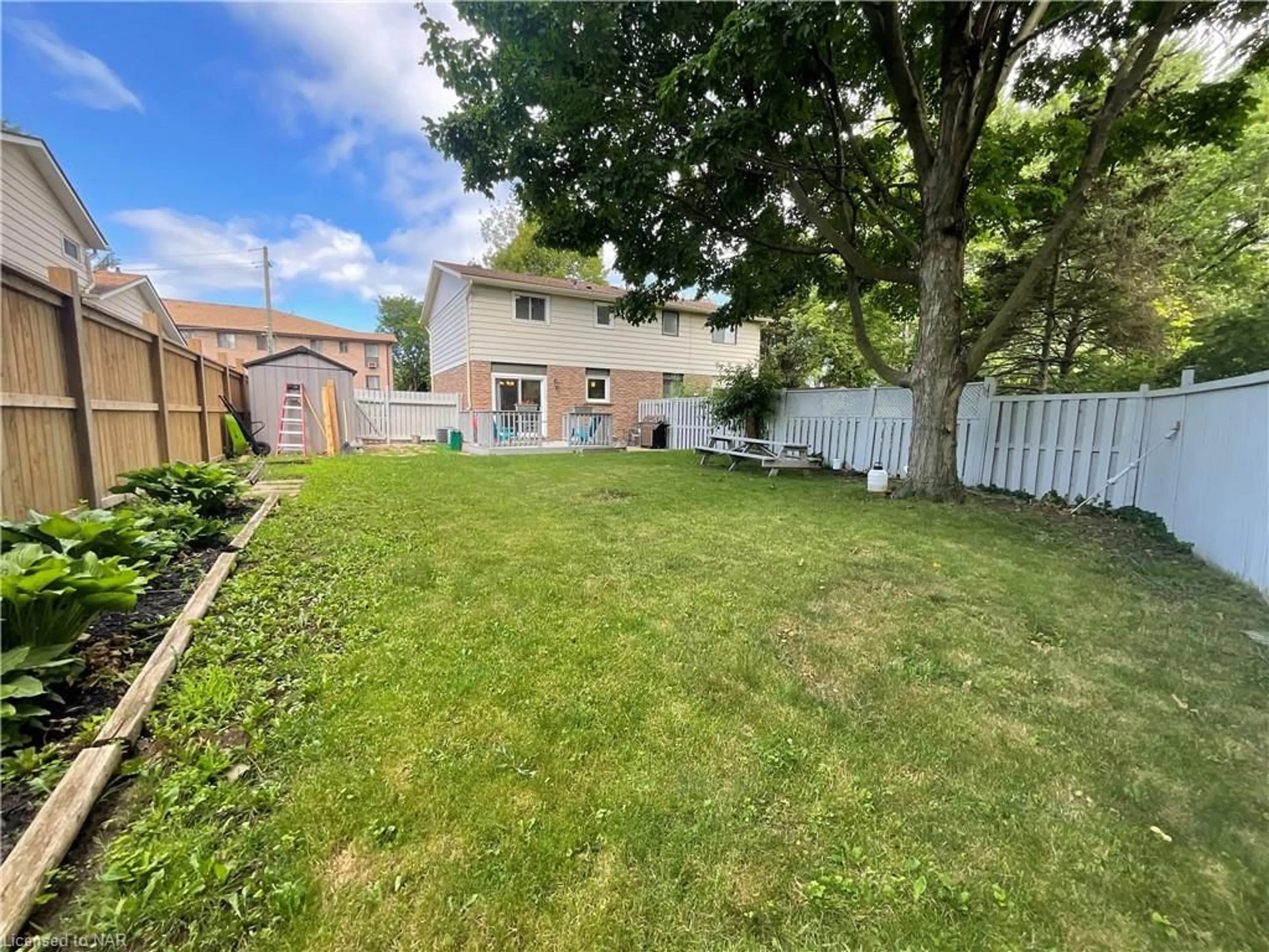 Frontside or backside of a home, the fenced backyard for 14 Stockwell Rd, St. Catharines Ontario L2N 6P7