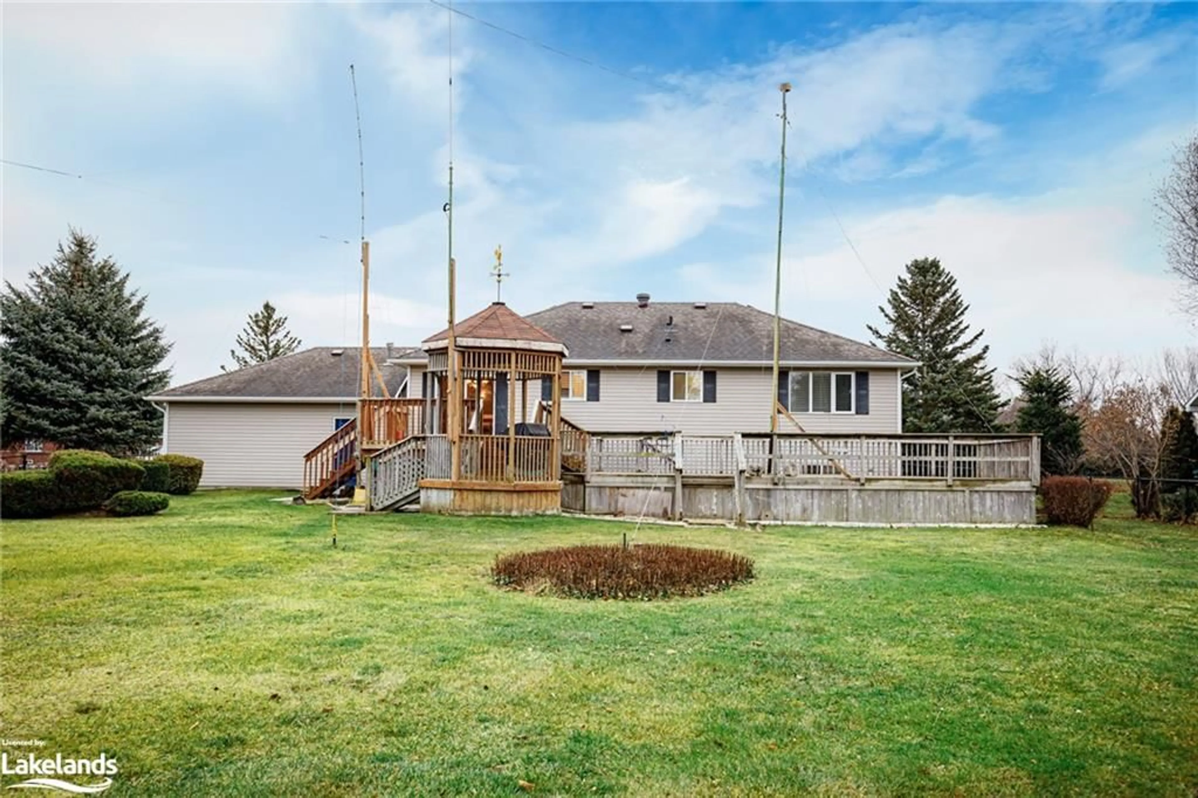 Frontside or backside of a home, the fenced backyard for 38 Mckean Blvd, Nottawa Ontario L0M 1P0