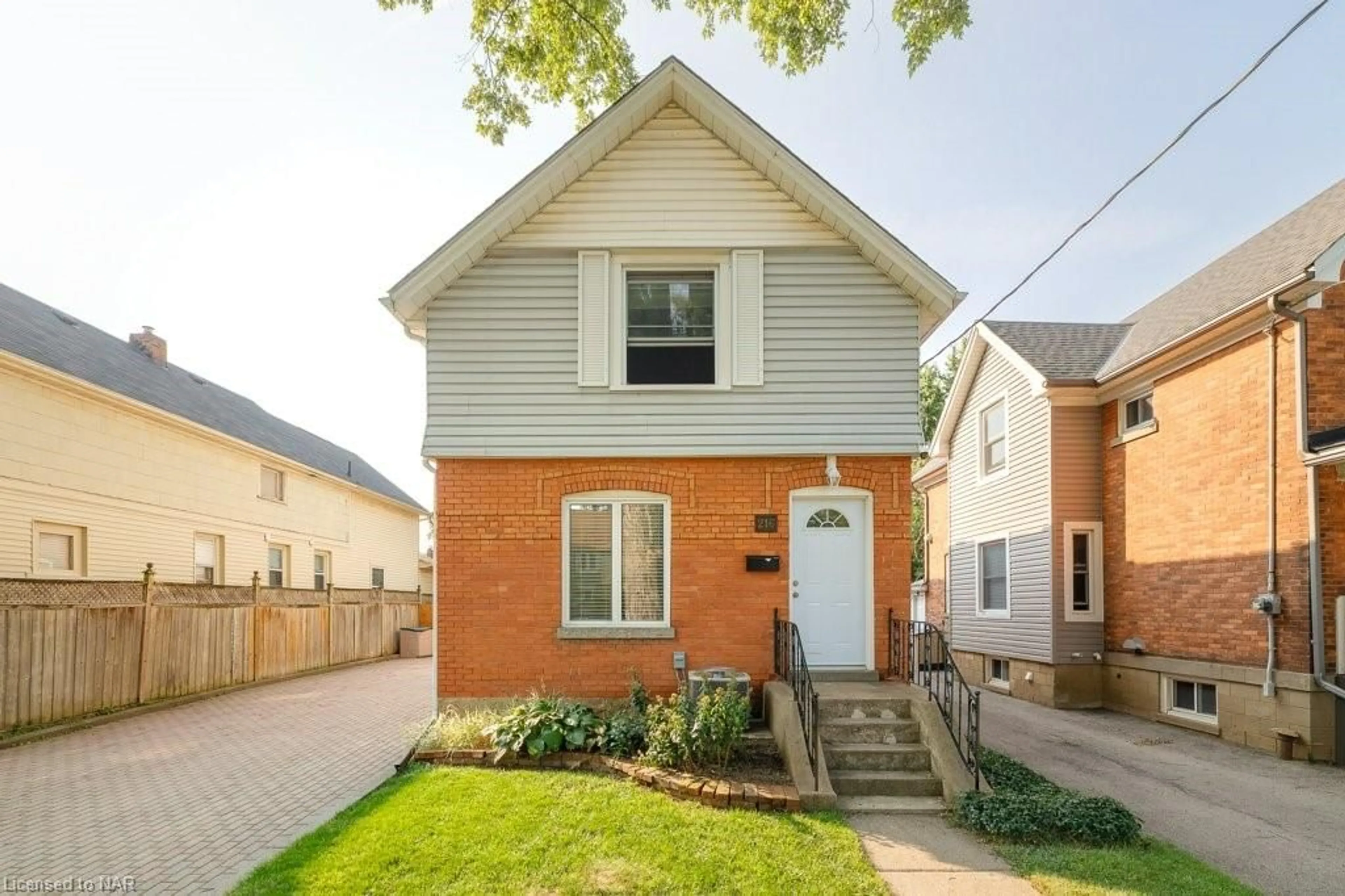 Frontside or backside of a home, the fenced backyard for 216 Russell Ave, St. Catharines Ontario L2R 1W8