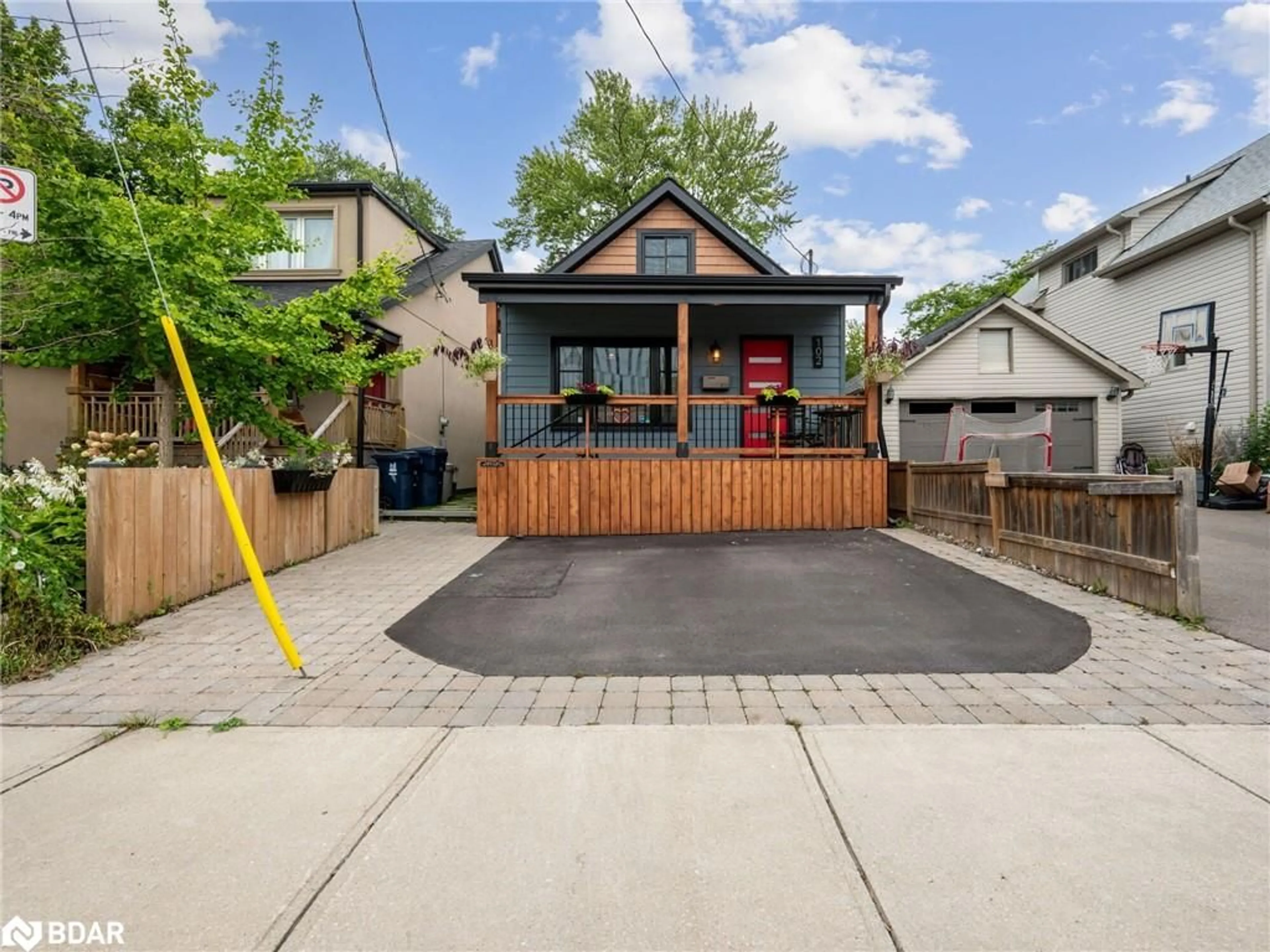 Frontside or backside of a home, the fenced backyard for 102 Twenty Third Street, Toronto Ontario M8V 3N2