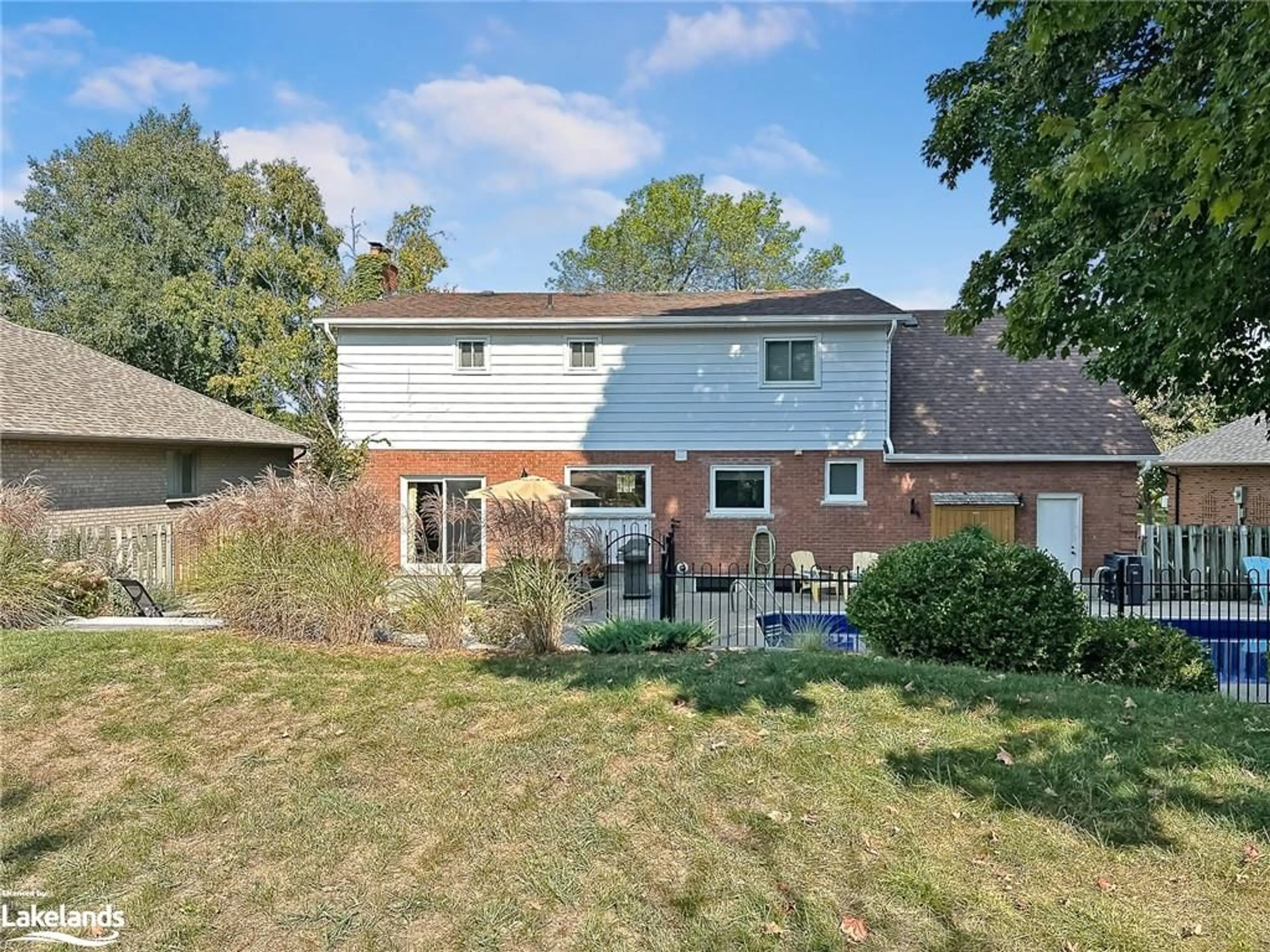 Frontside or backside of a home, the fenced backyard for 62 Lockhart Rd, Collingwood Ontario L9Y 2L3