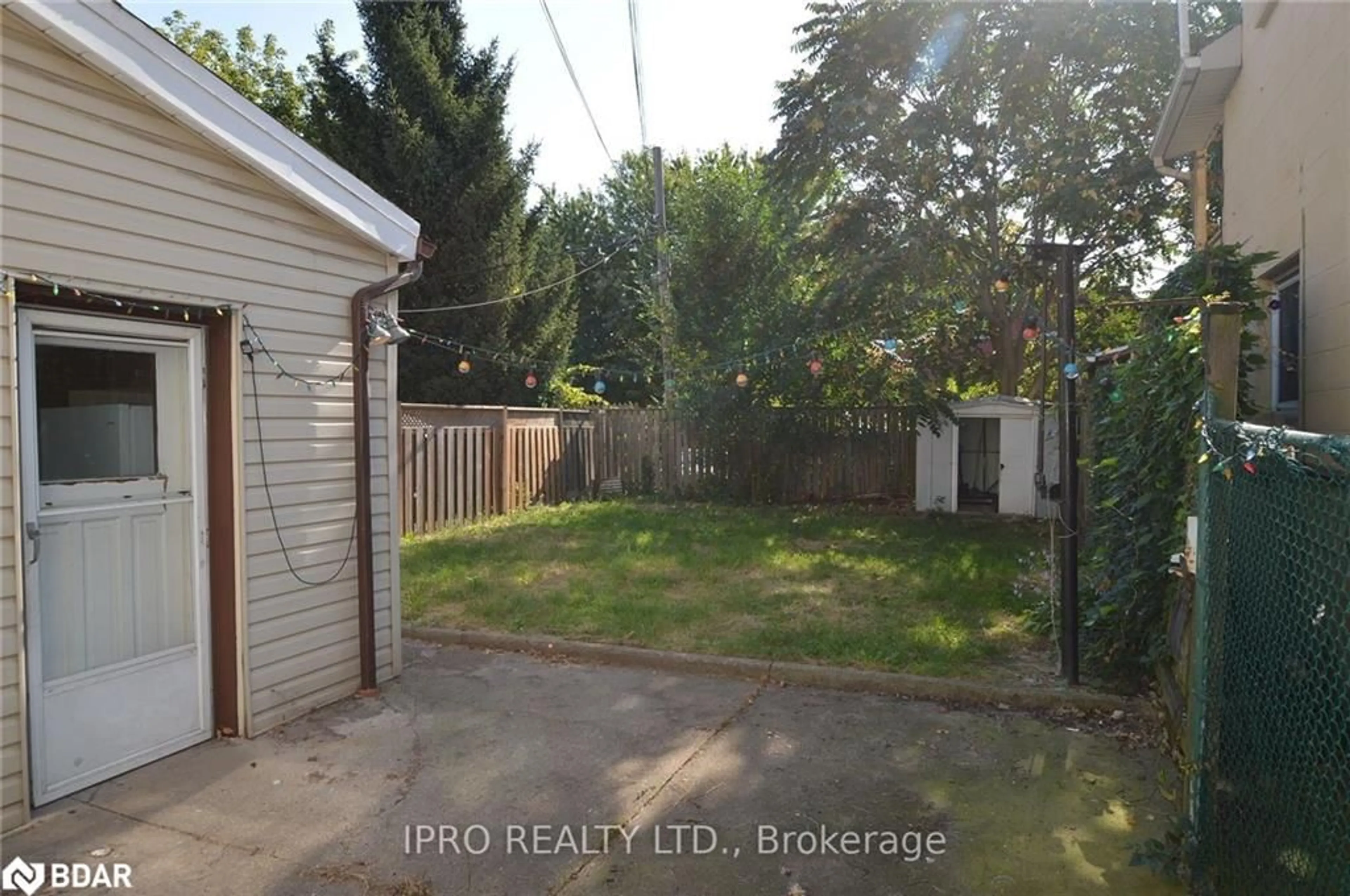 Frontside or backside of a home, the fenced backyard for 164 Macnab St, Hamilton Ontario L8R 2M4