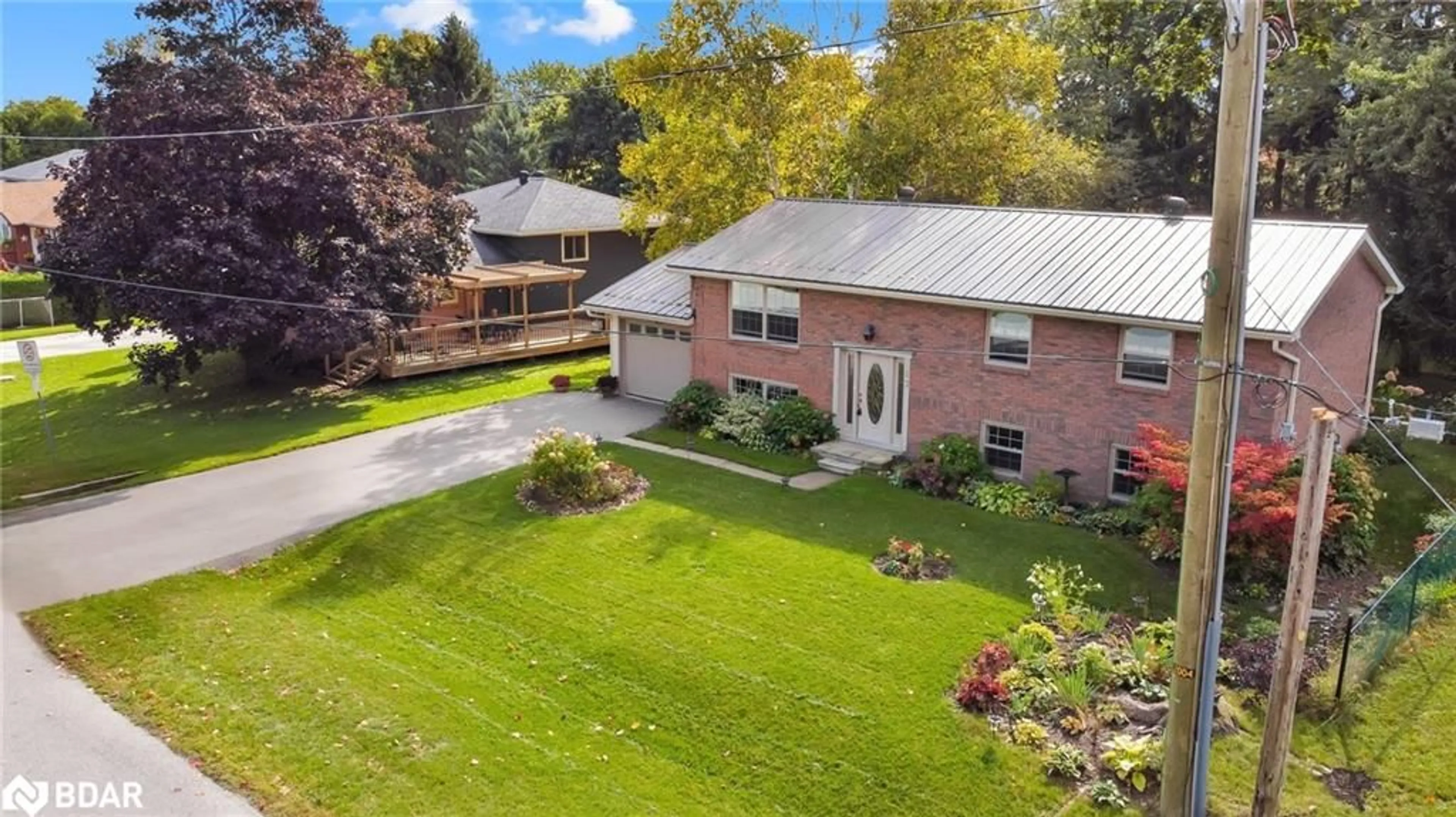 Frontside or backside of a home, the fenced backyard for 13 Jardine Cres, Creemore Ontario L0M 1G0