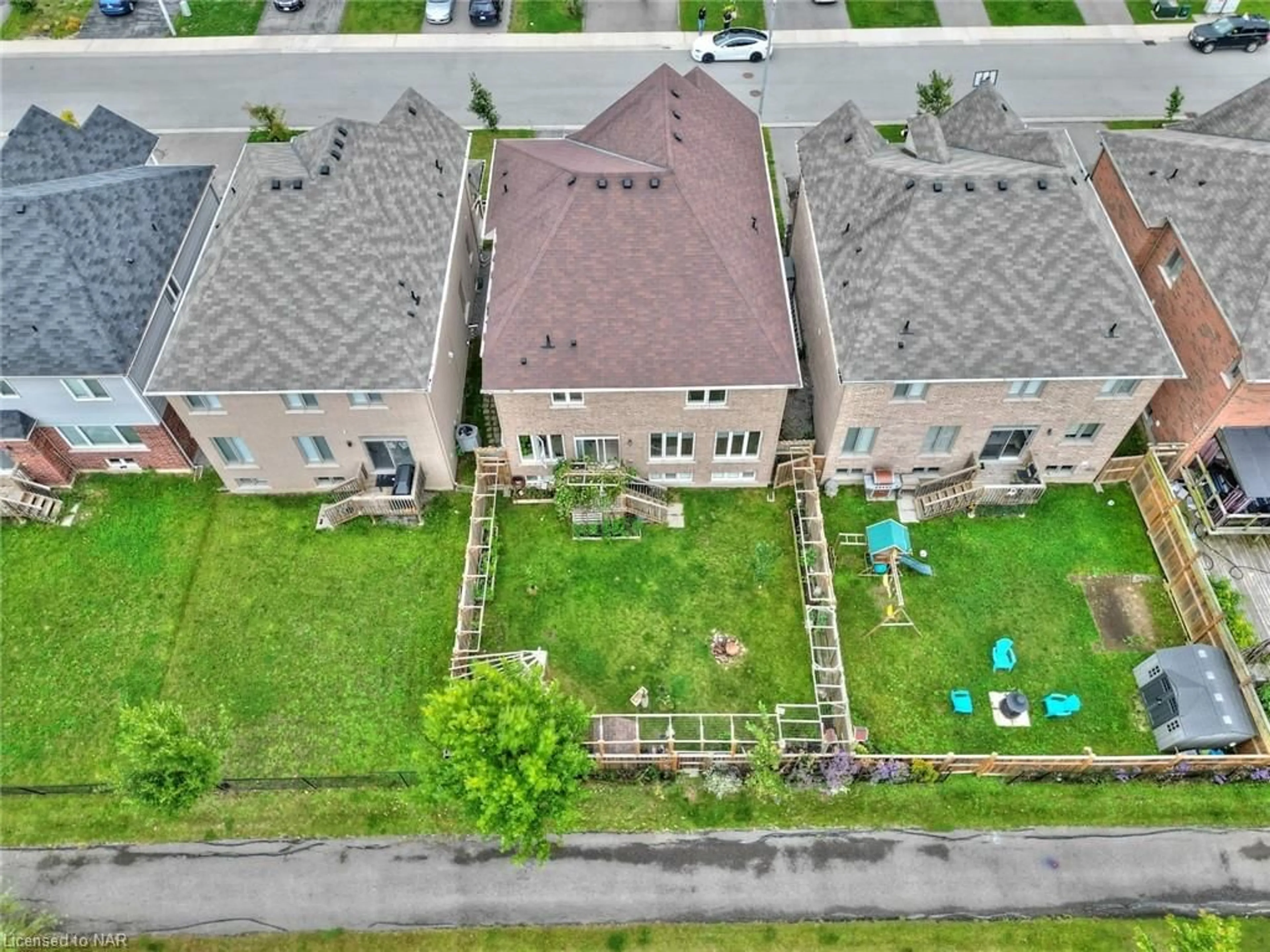 Frontside or backside of a home, the fenced backyard for 7721 Sassafras Trail, Niagara Falls Ontario L2H 0N5