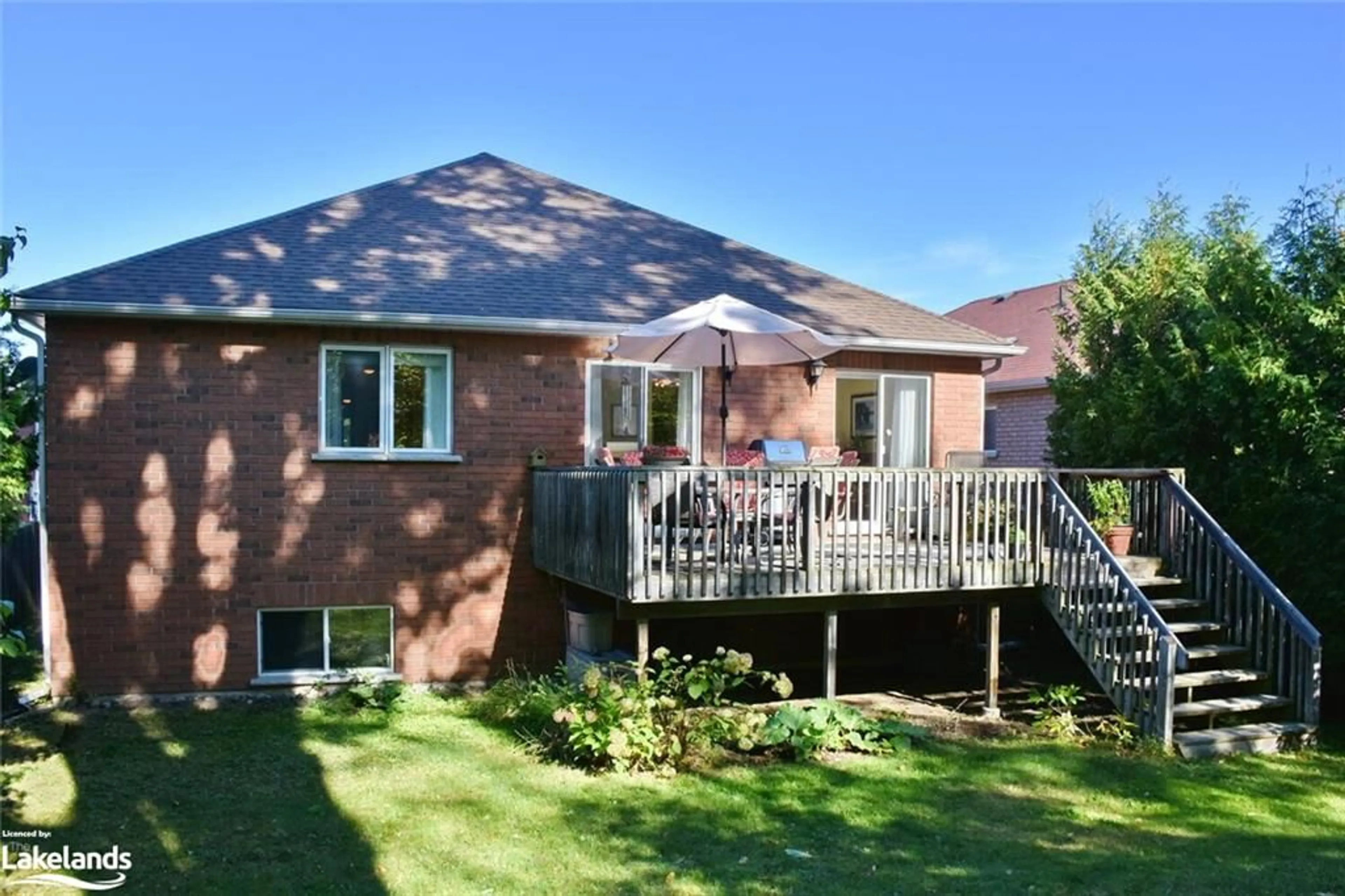 Frontside or backside of a home, the fenced backyard for 13 Tona Trail, Wasaga Beach Ontario L9Z 0A5