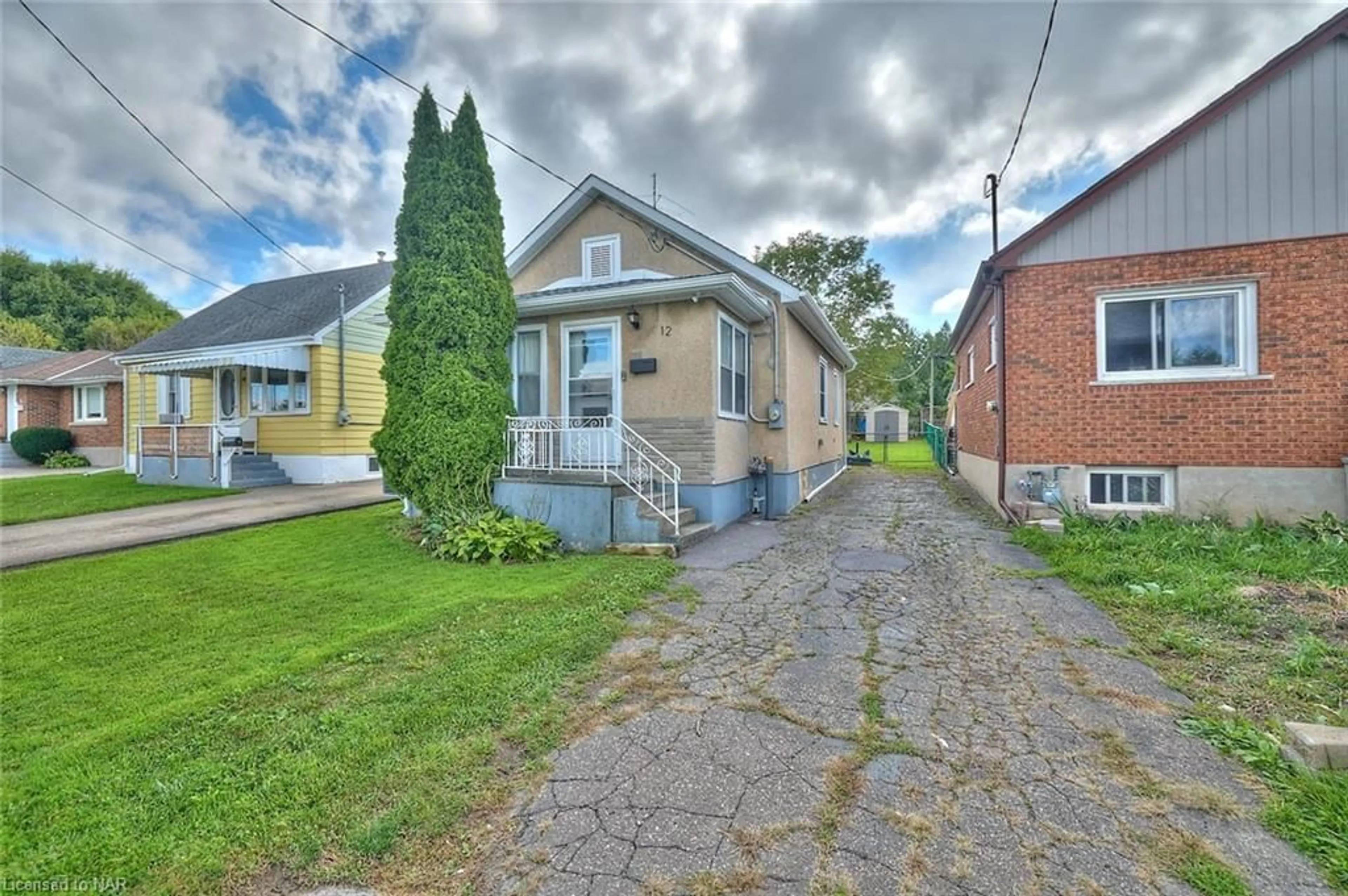 Frontside or backside of a home, the street view for 12 Fairburn Ave, St. Catharines Ontario L2T 1B2