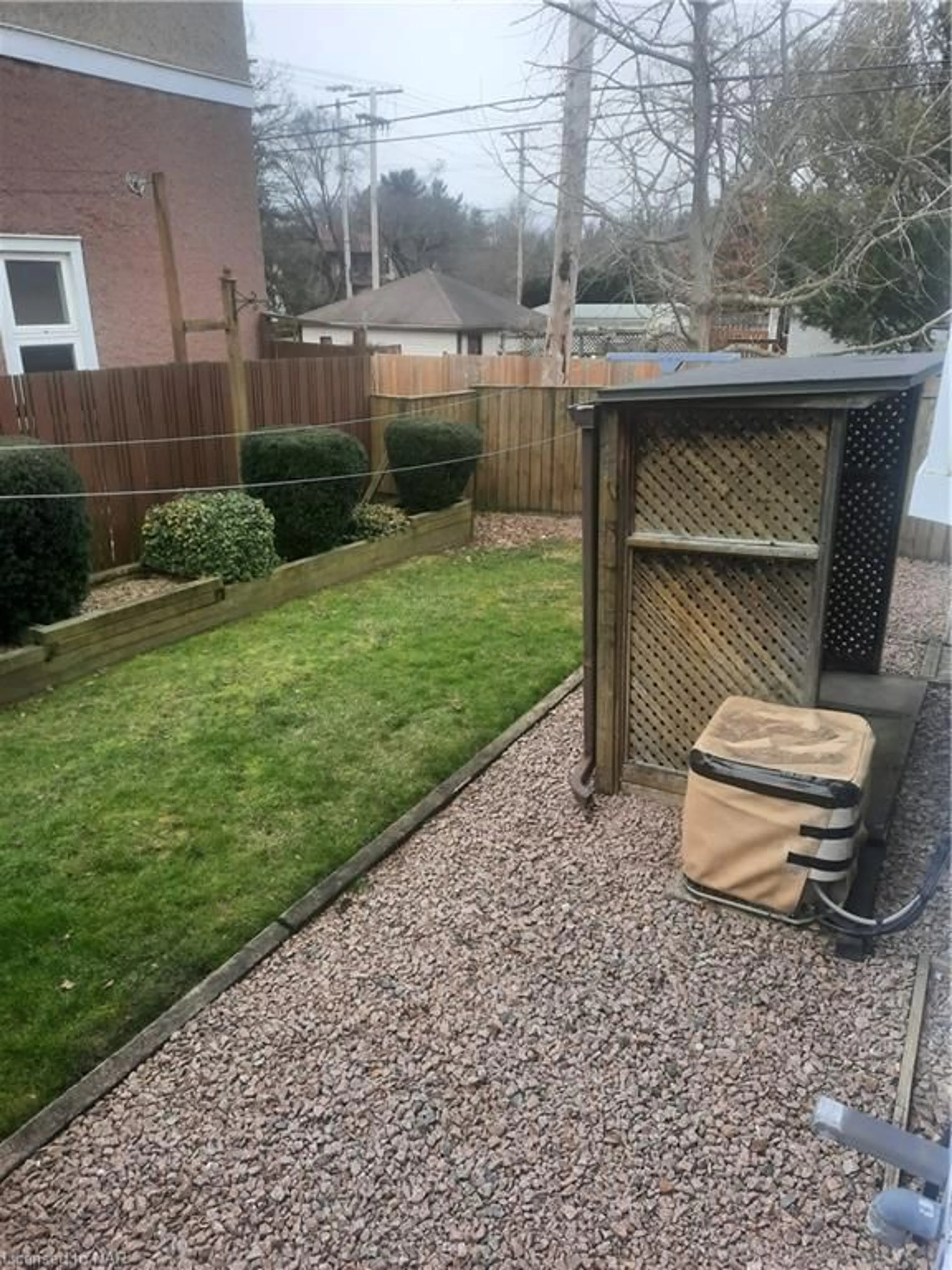 Frontside or backside of a home, the fenced backyard for 169-171 Merritt St, Welland Ontario L3C 4T7