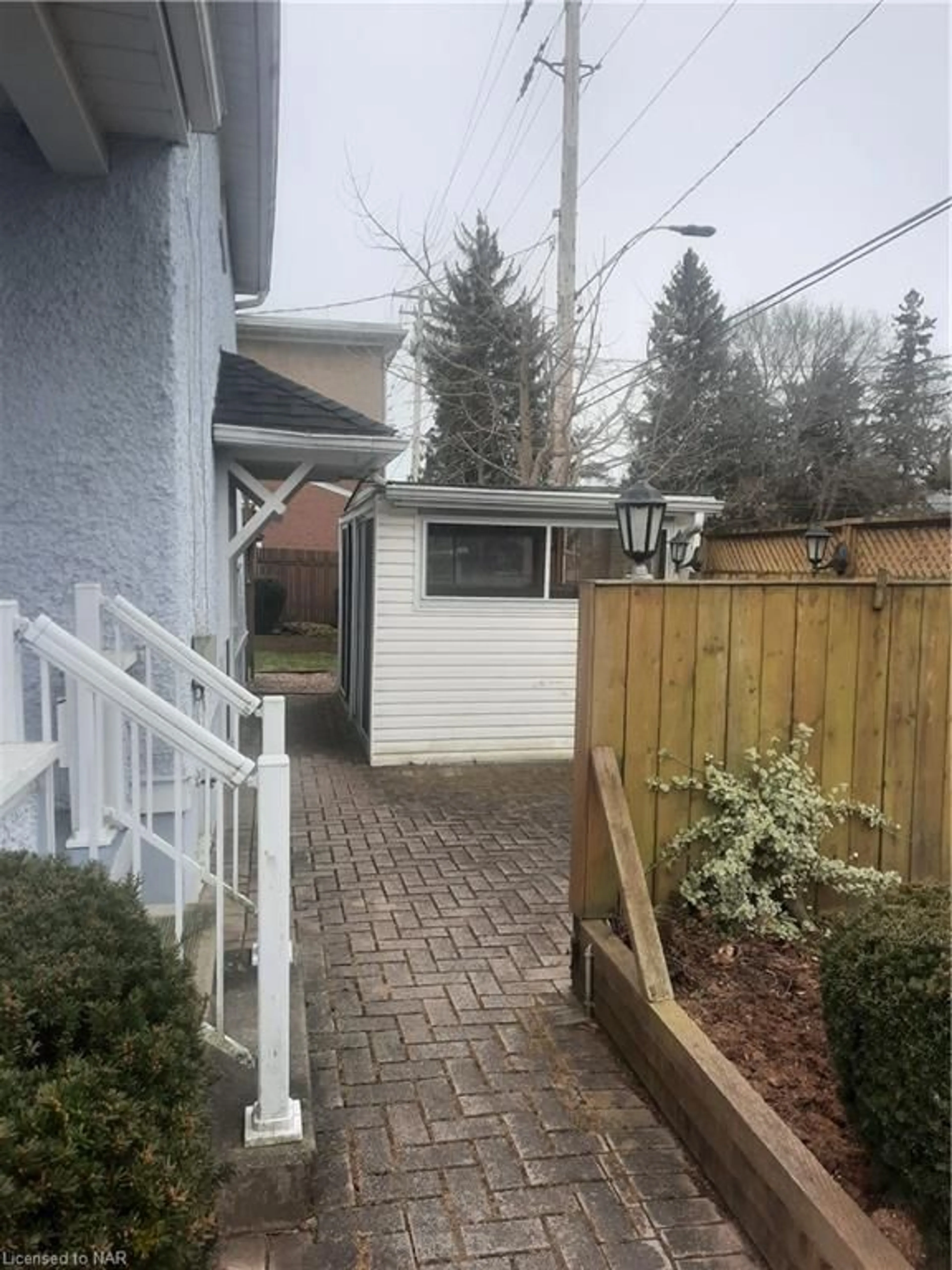 Frontside or backside of a home, the fenced backyard for 169-171 Merritt St, Welland Ontario L3C 4T7