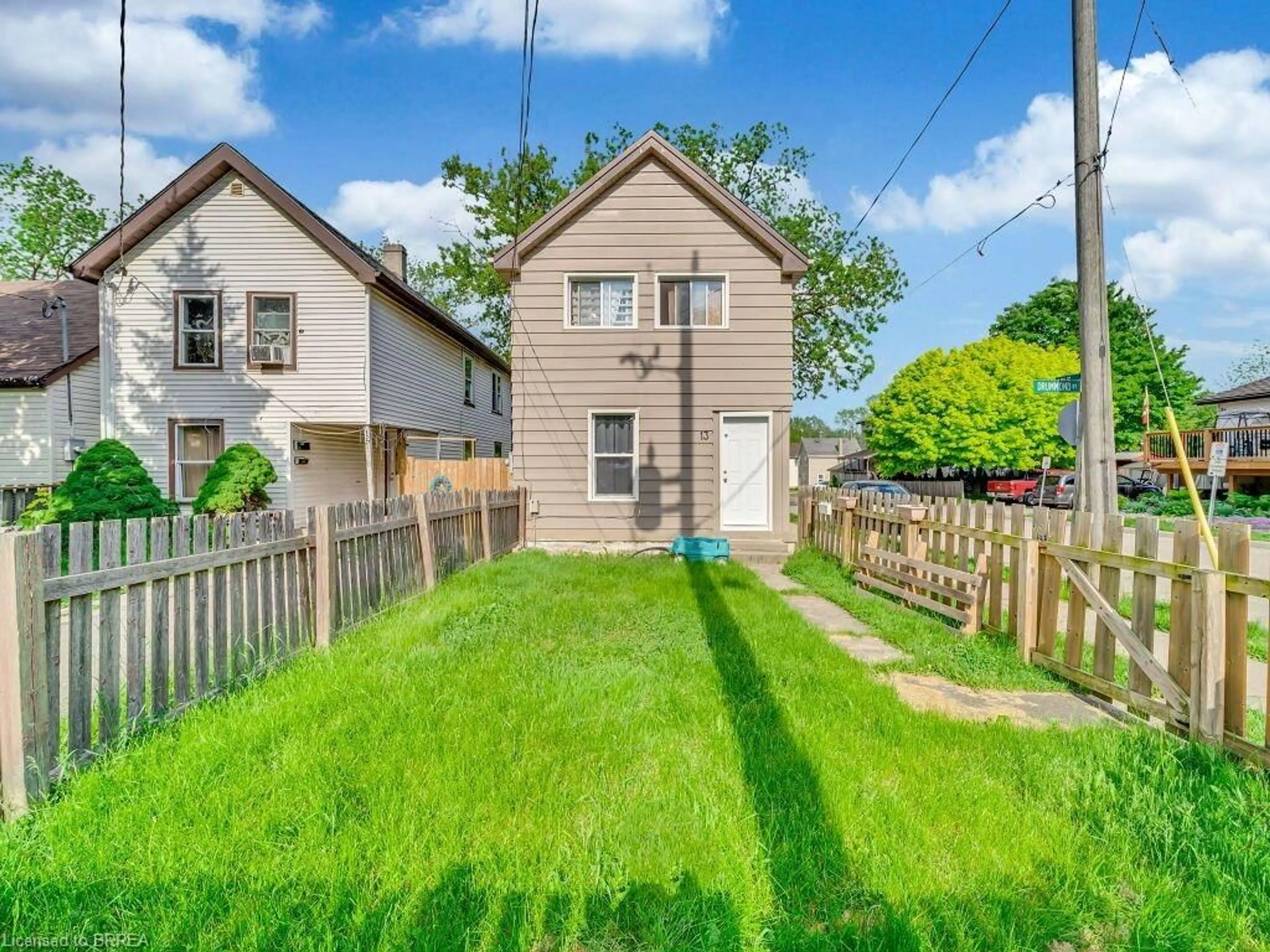 Frontside or backside of a home, the fenced backyard for 13 Drummond St, Brantford Ontario N3S 5Z2