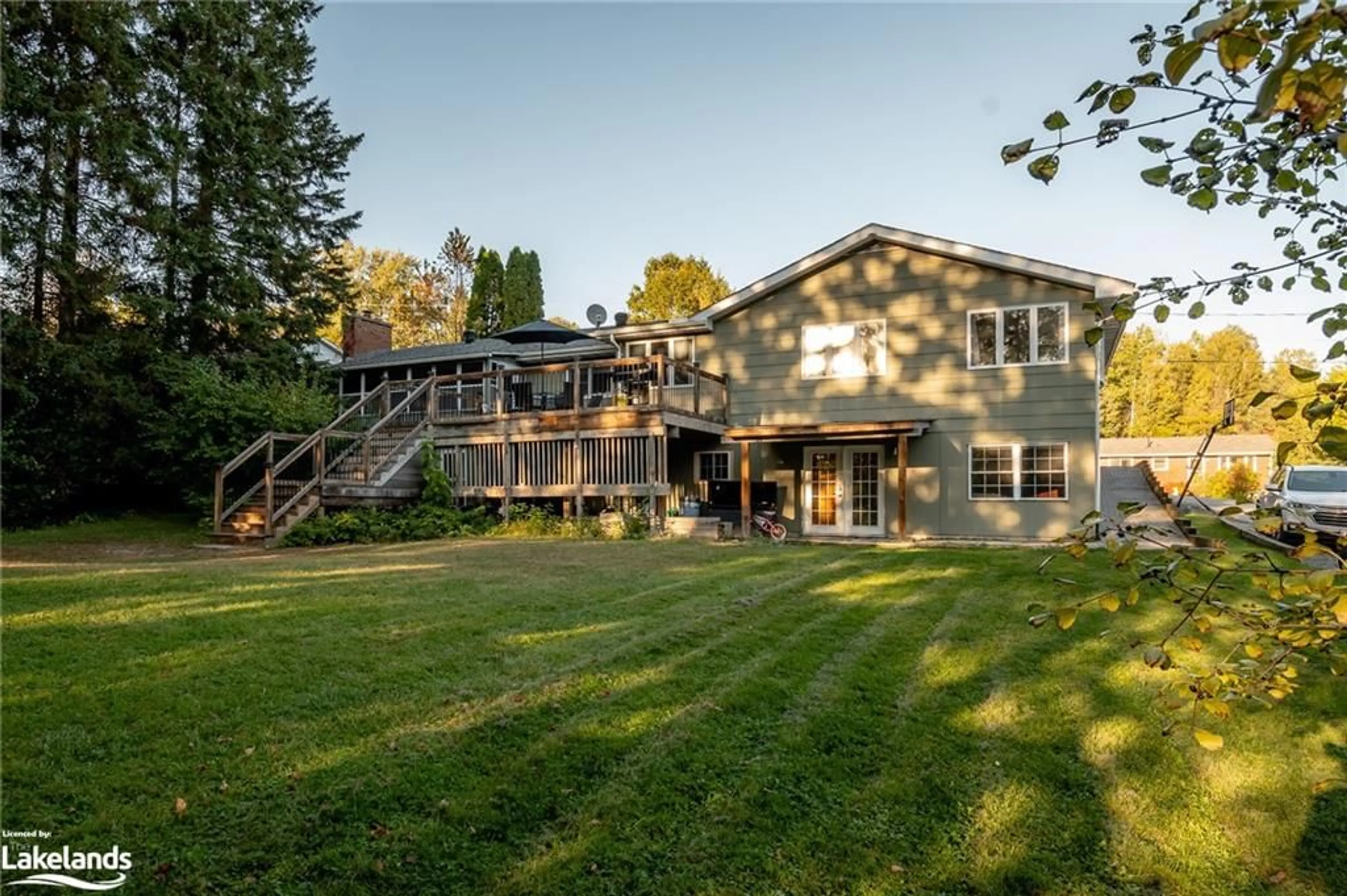 Frontside or backside of a home, the fenced backyard for 32 Gullins Rd, Huntsville Ontario P1H 1M6