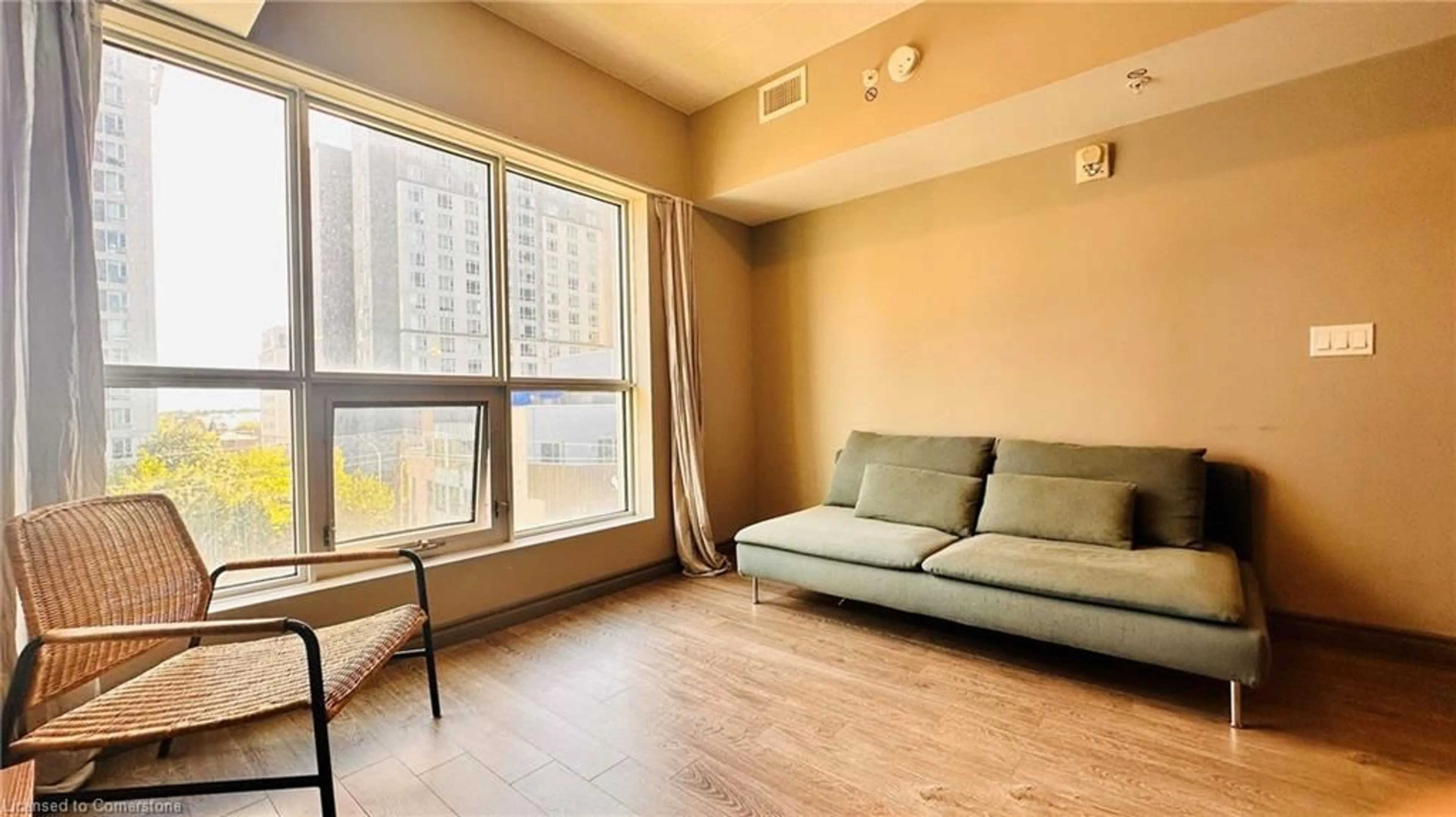 Living room with furniture, wood/laminate floor for 321 Spruce St #605, Waterloo Ontario N2L 0G4