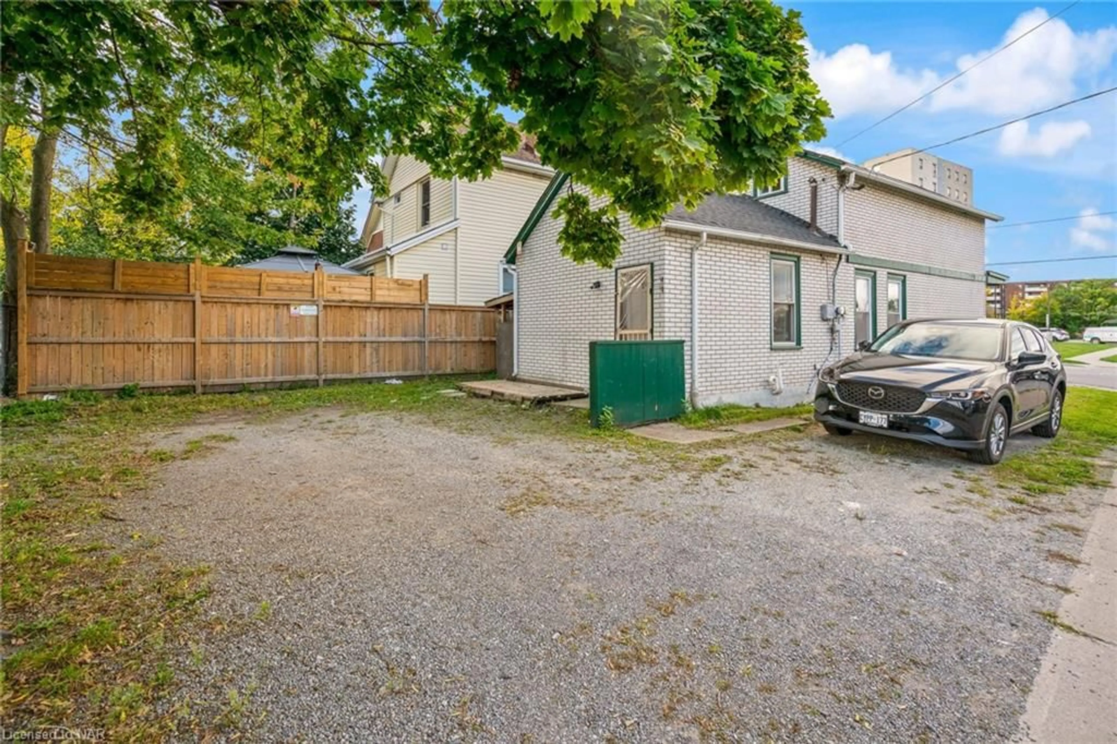 Frontside or backside of a home, the fenced backyard for 58 Court St, St. Catharines Ontario L2R 4S1