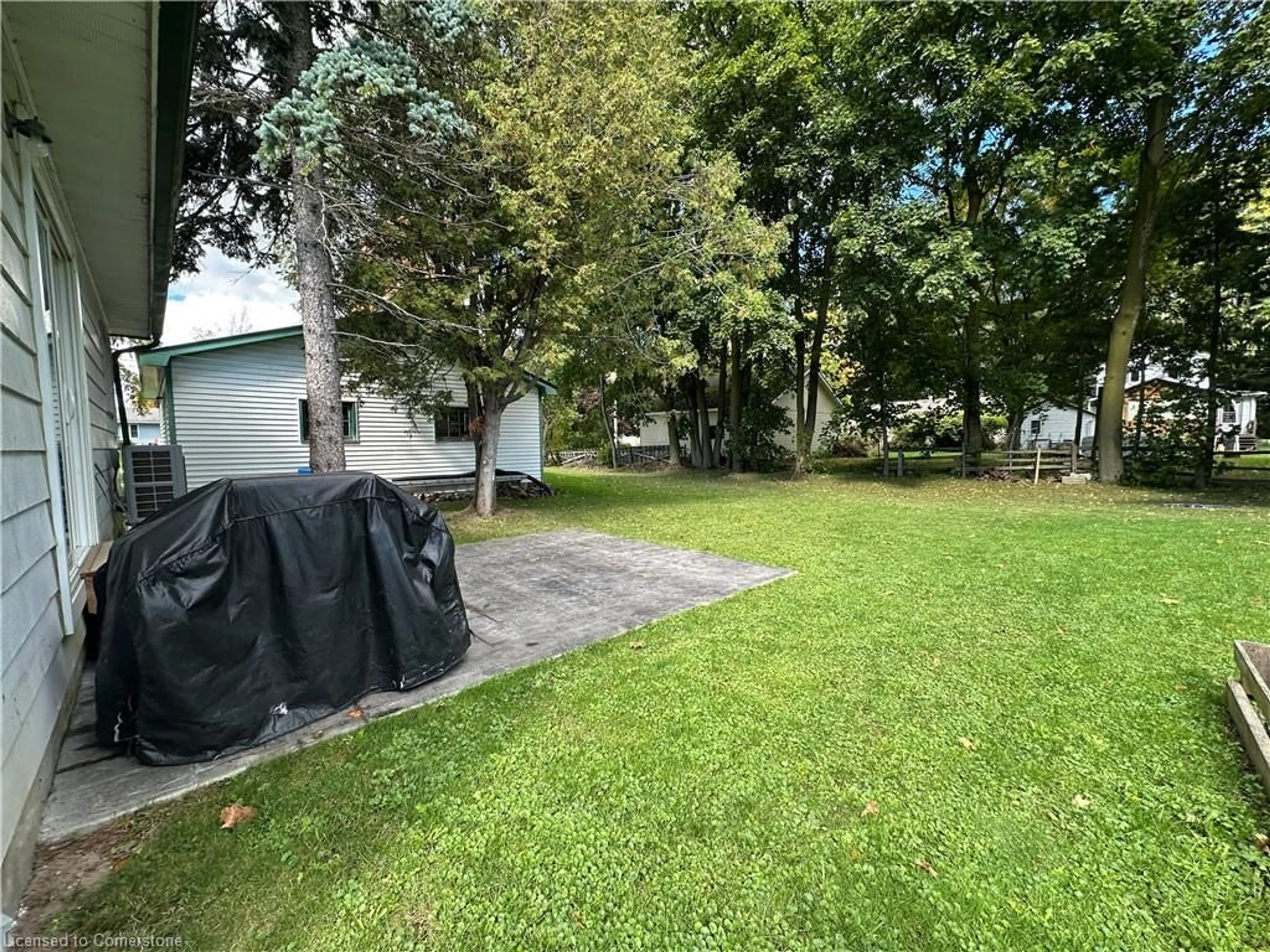 Frontside or backside of a home, the fenced backyard for 570 Lowe St, Palmerston Ontario N0G 2P0