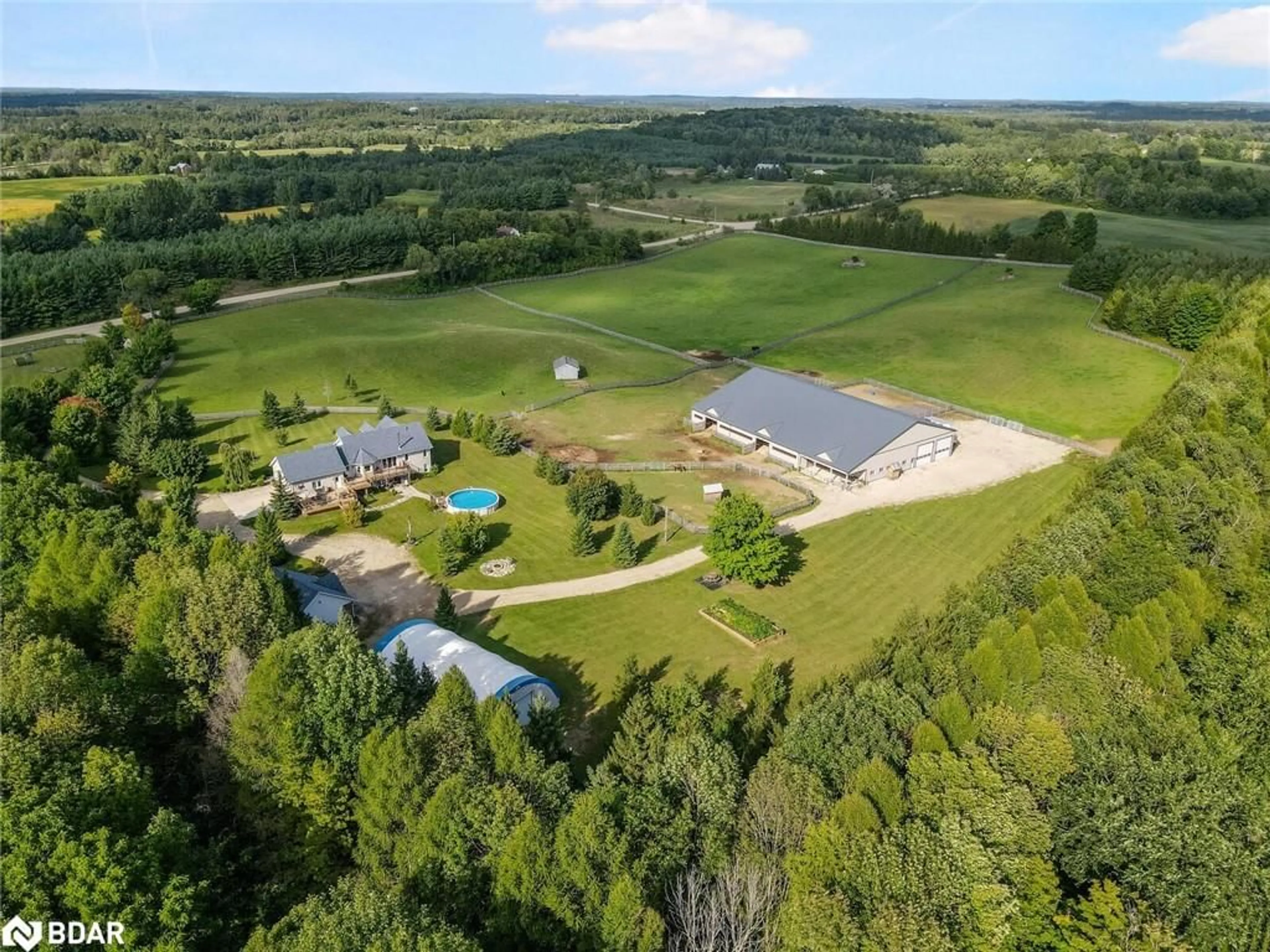 A pic from exterior of the house or condo, the fenced backyard for 102554 Road 49 Rd, West Grey Ontario N0G 1C0