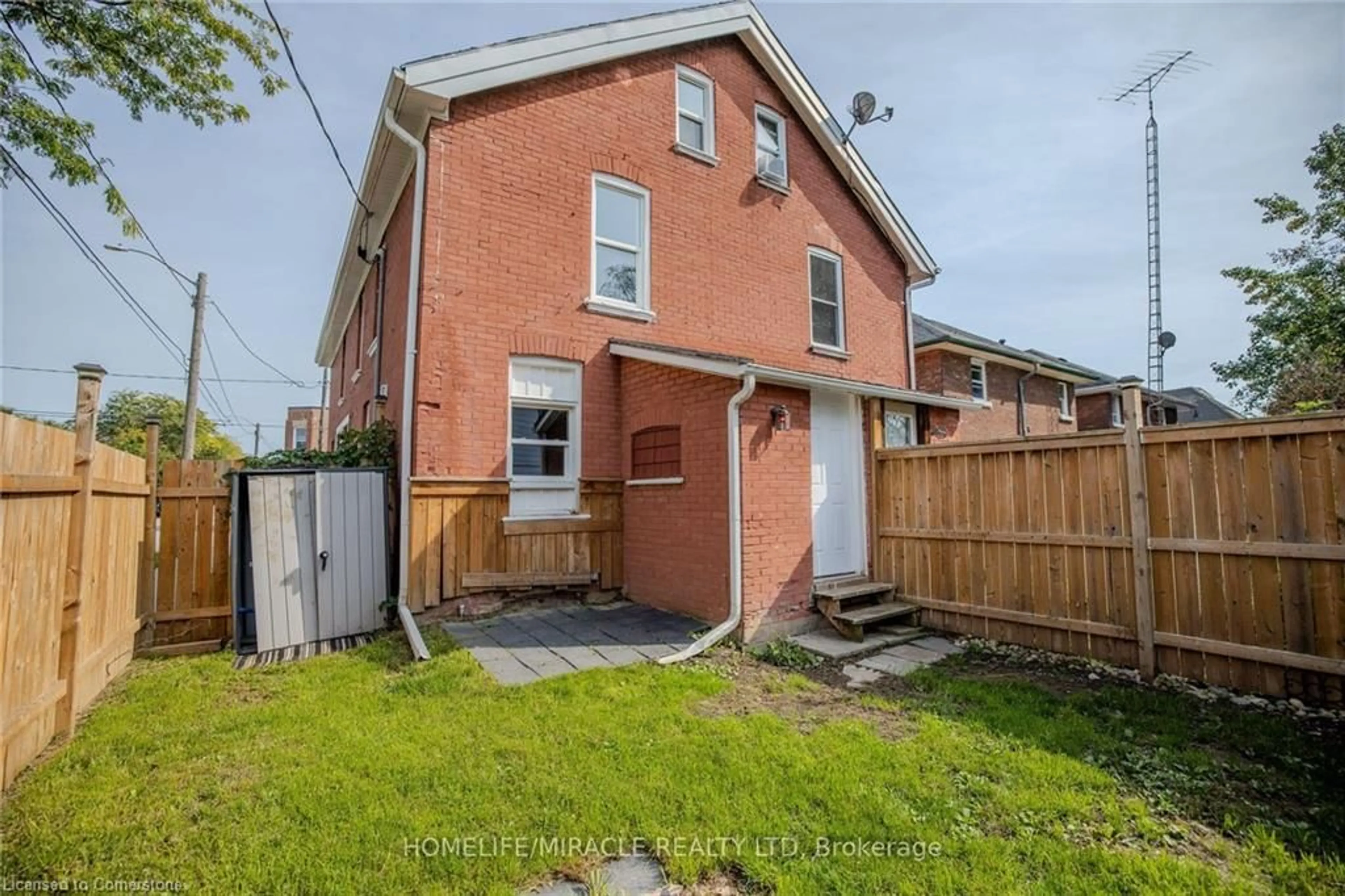 Frontside or backside of a home, the fenced backyard for 139 Superior St, Brantford Ontario N3S 2L3