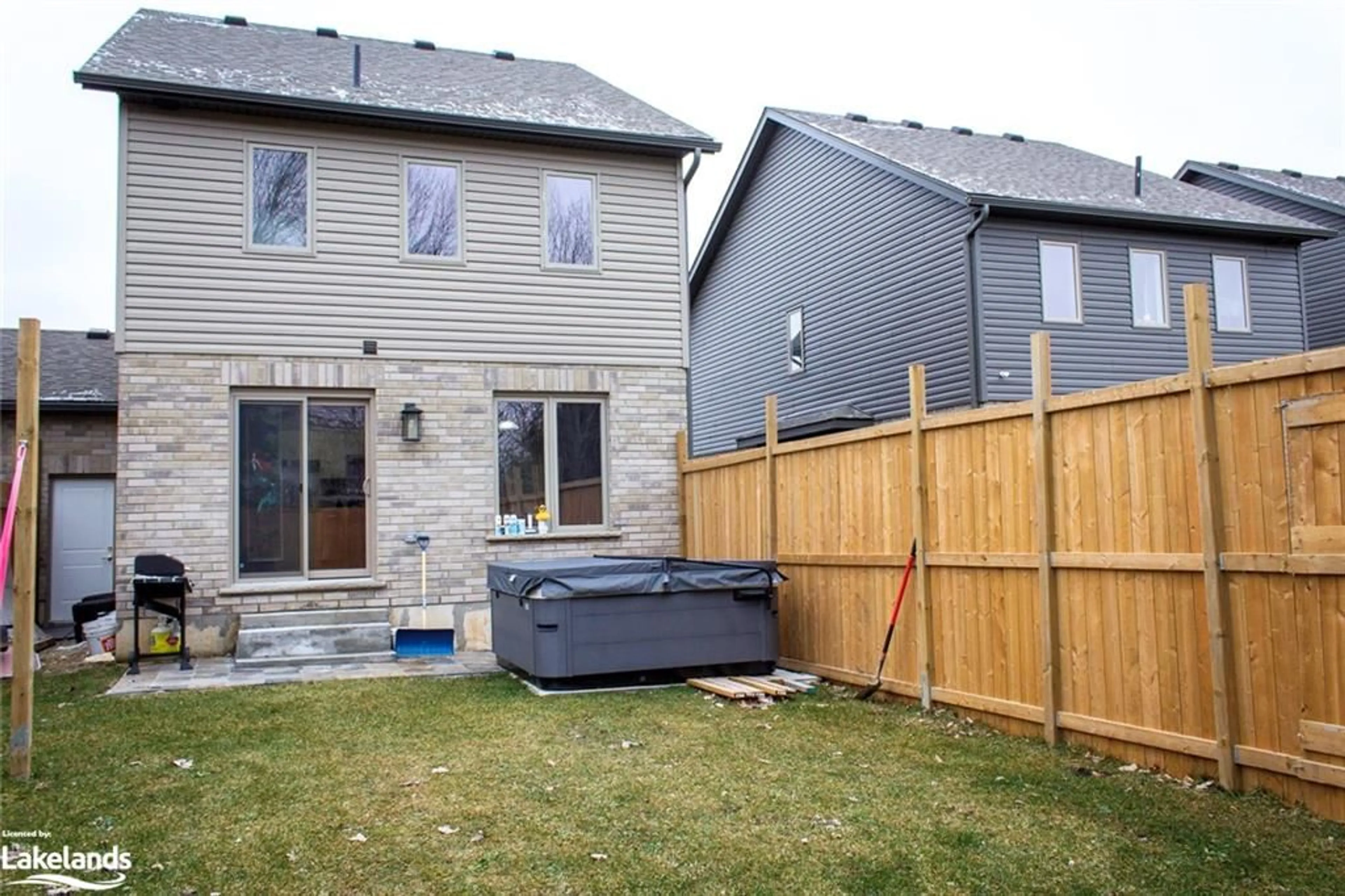 Frontside or backside of a home, the fenced backyard for 131 Stonebrook Way, Markdale Ontario N0C 1H0